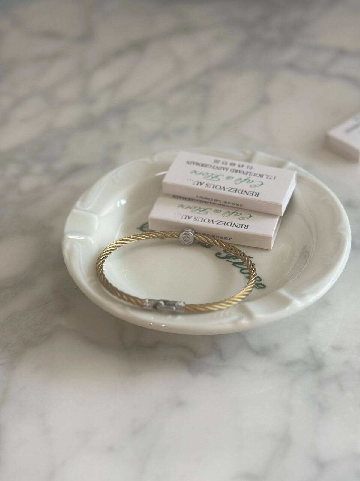 Louise Row Studio featuring Alor cable bracelet on plate on grey table showing back signature