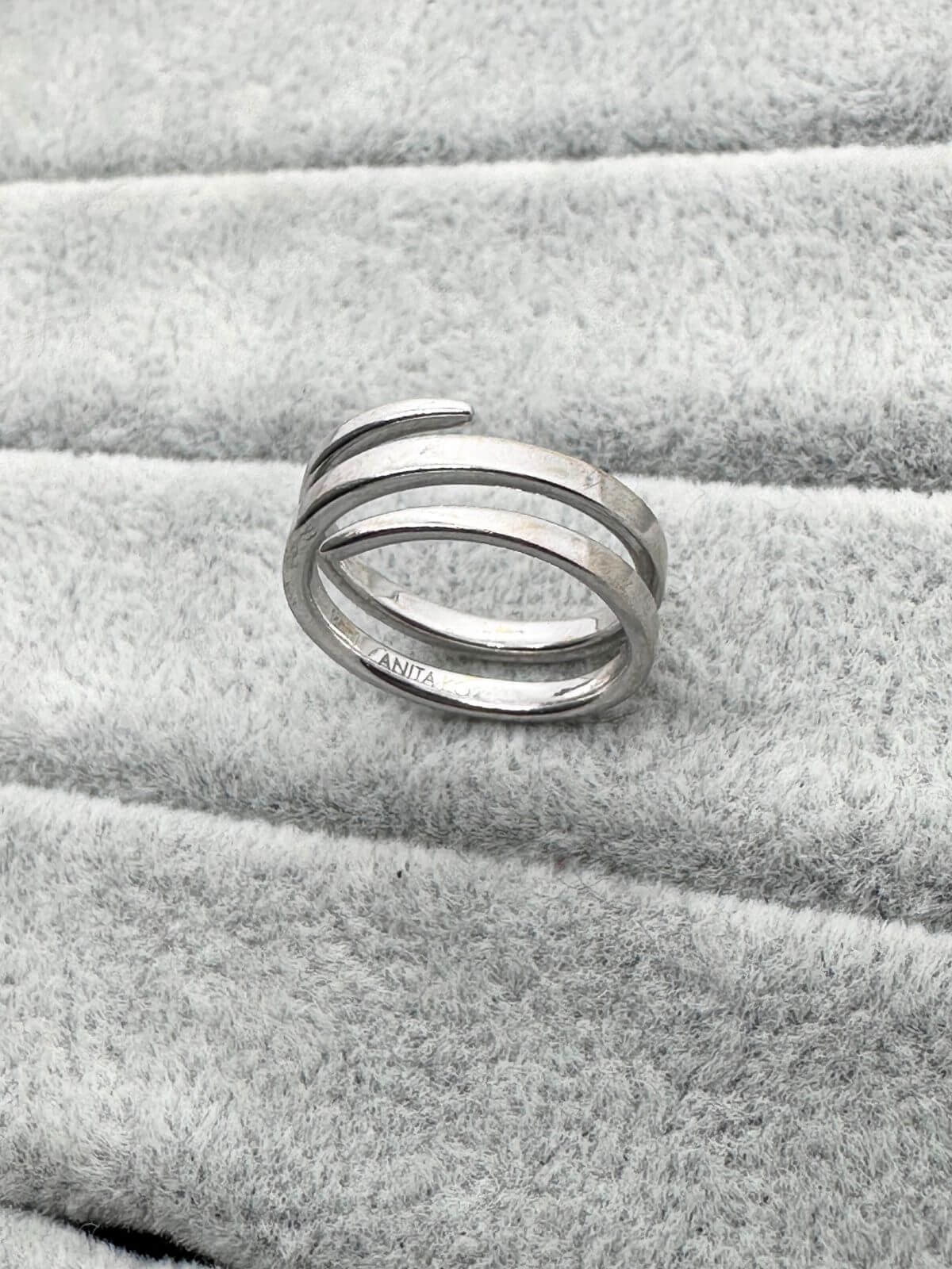 Anita Ko white gold coil ring on grey fixture.