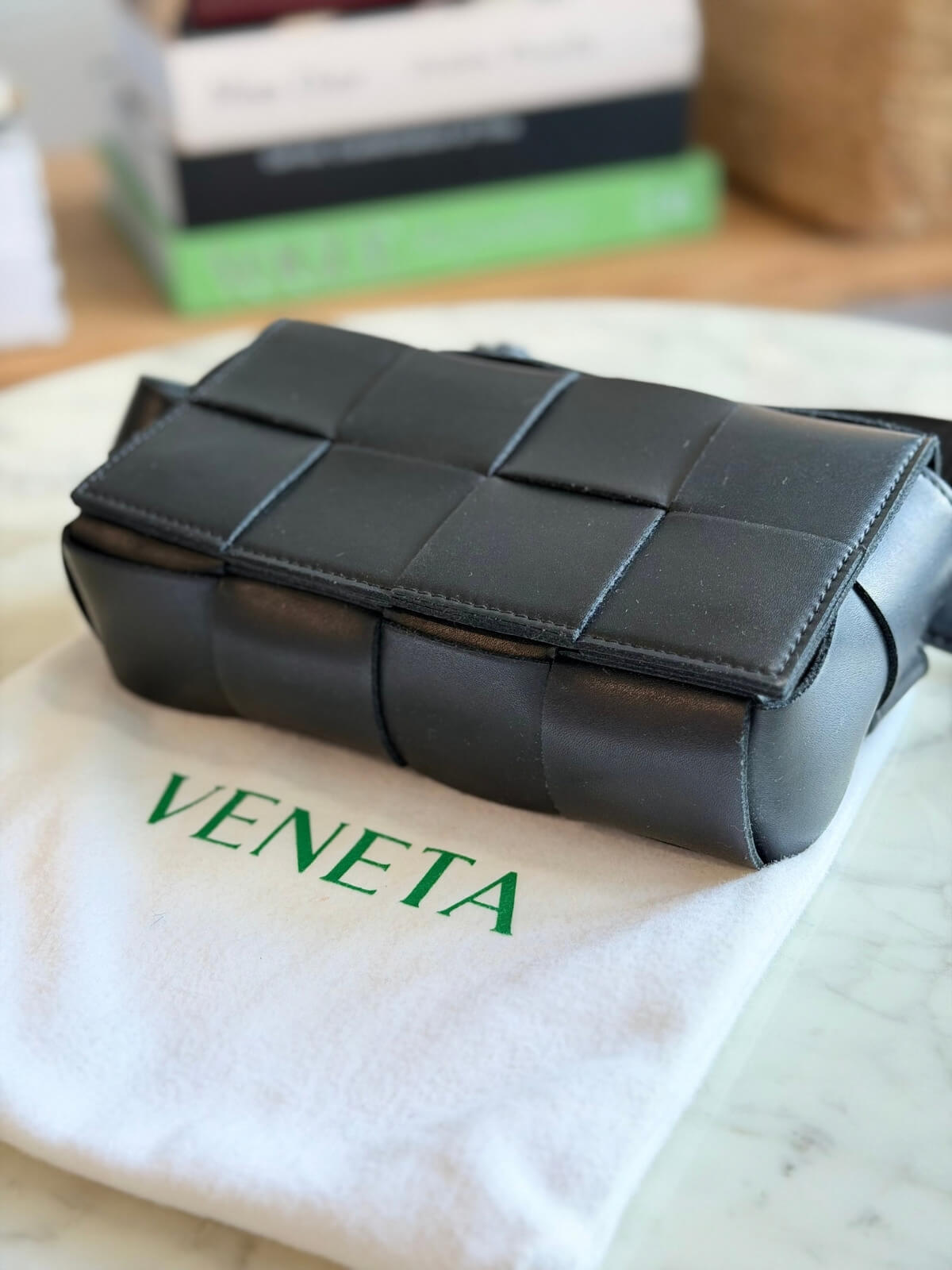 Louise Row featuring Bottega Cassette bag on table