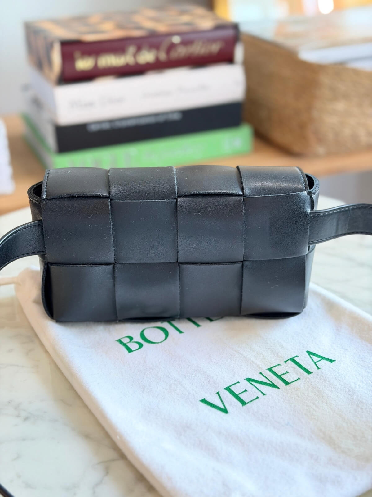 Louise Row featuring Bottega Cassette bag on table
