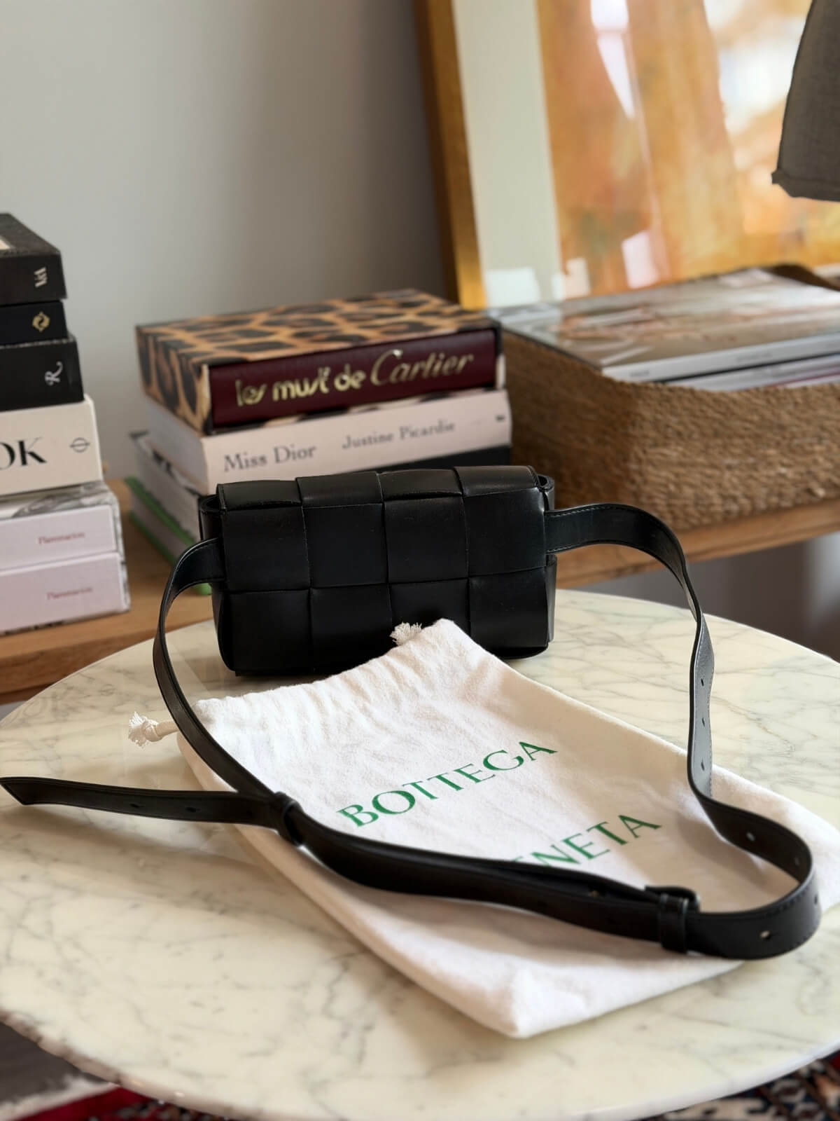 Louise Row featuring Bottega Cassette bag on table
