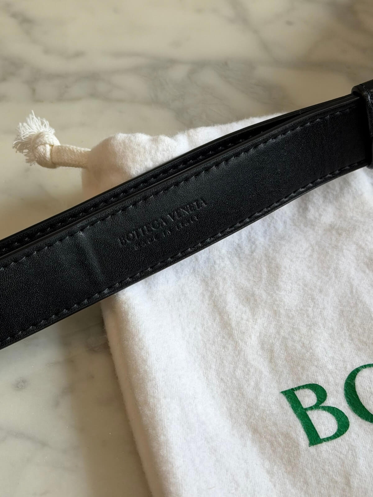 Louise Row featuring Bottega Cassette bag on table