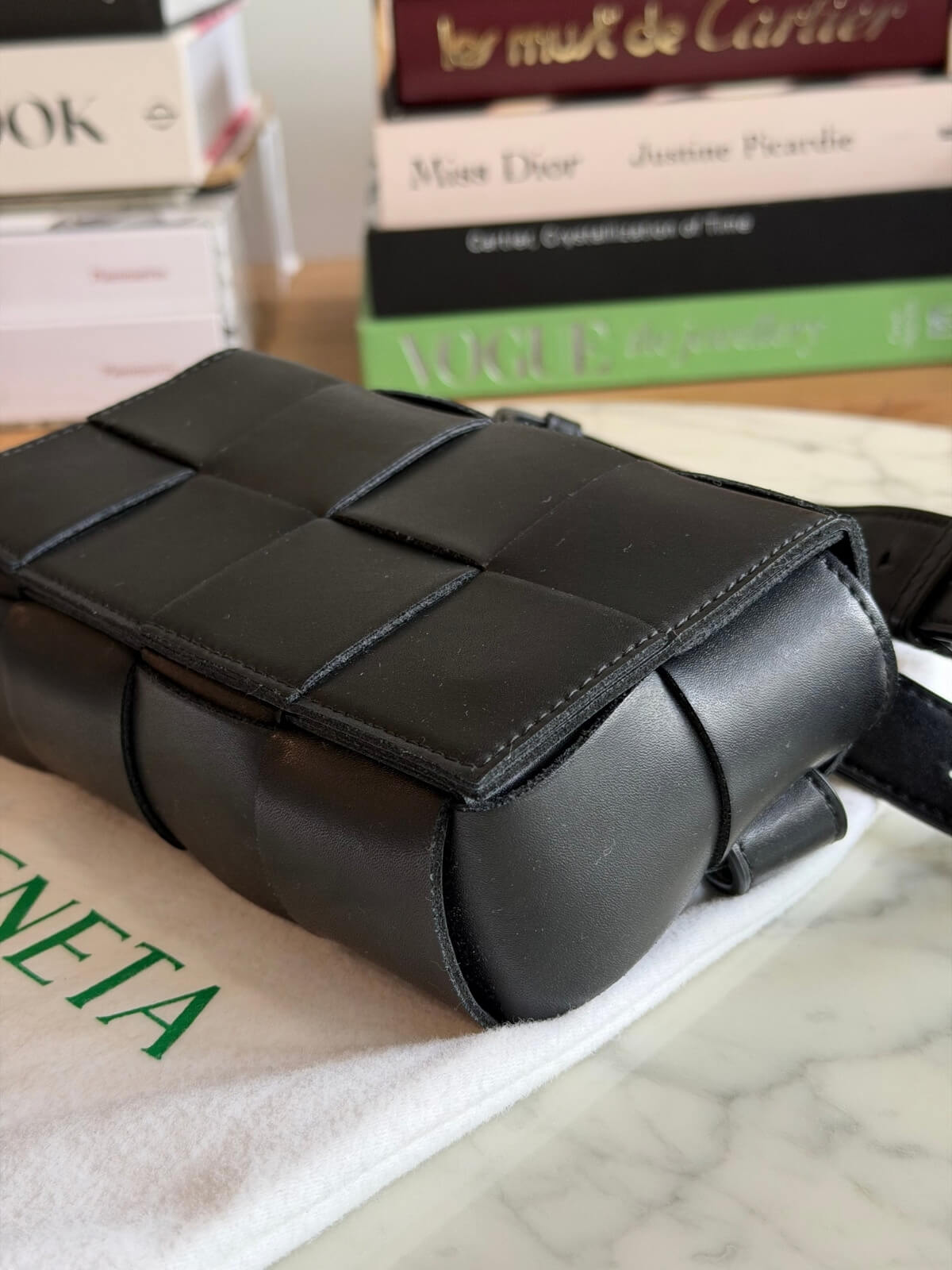 Louise Row featuring Bottega Cassette bag on table