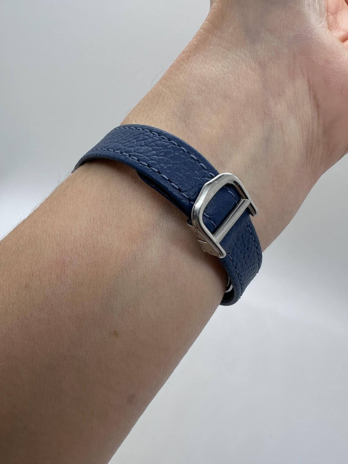 Back of Cartier Vendome watch showing blue strap and silver buckle on white background