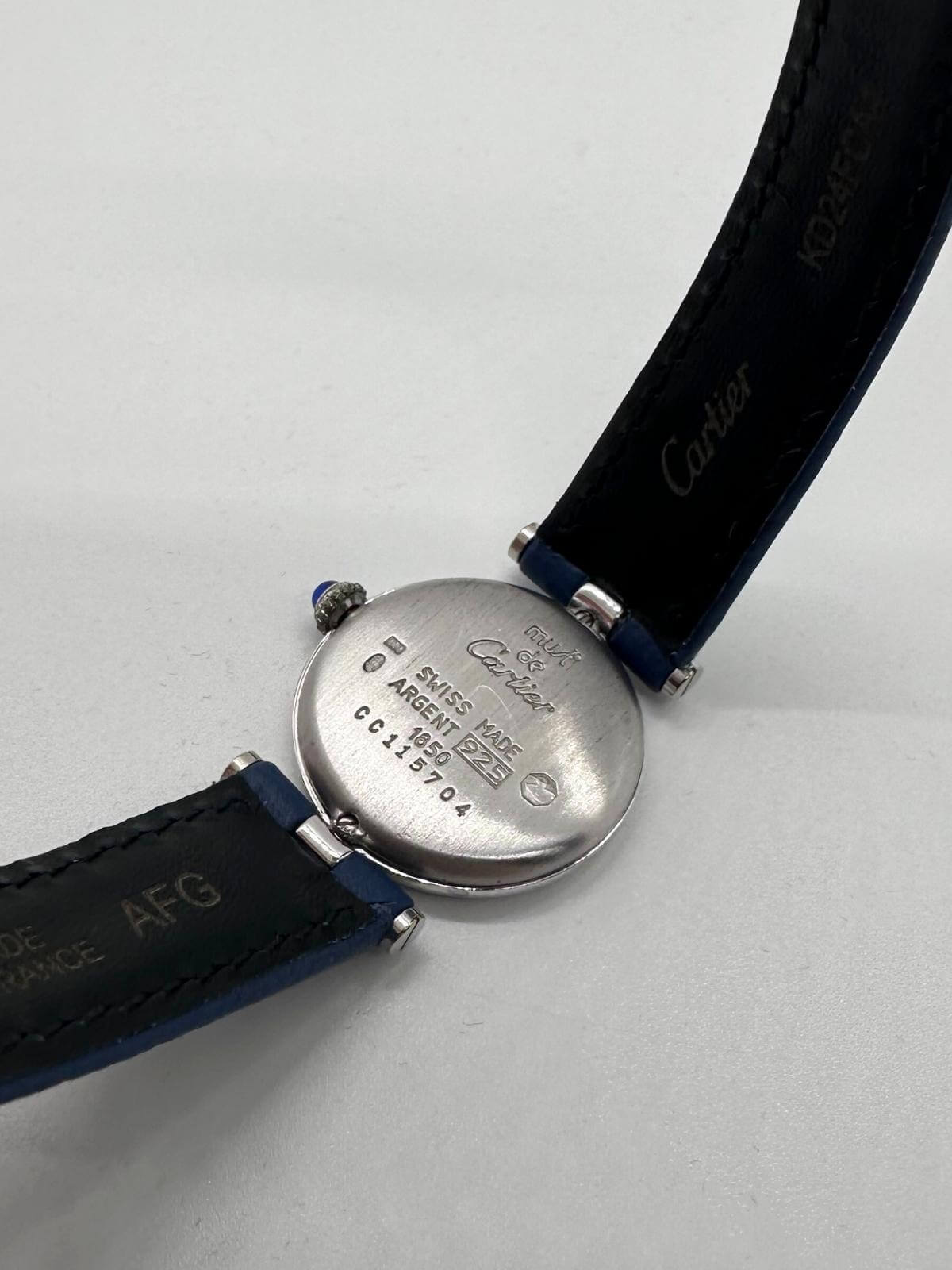 Back of case of Cartier Vendome watch with serial and description show on white background