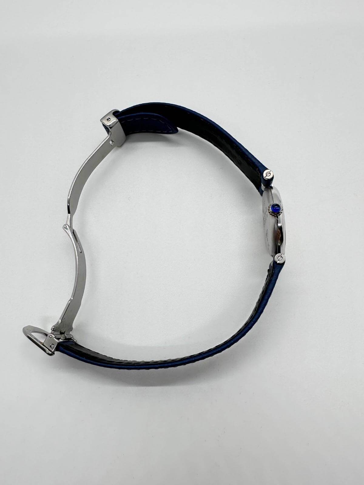 Side of watch showing profile of crown on a white background