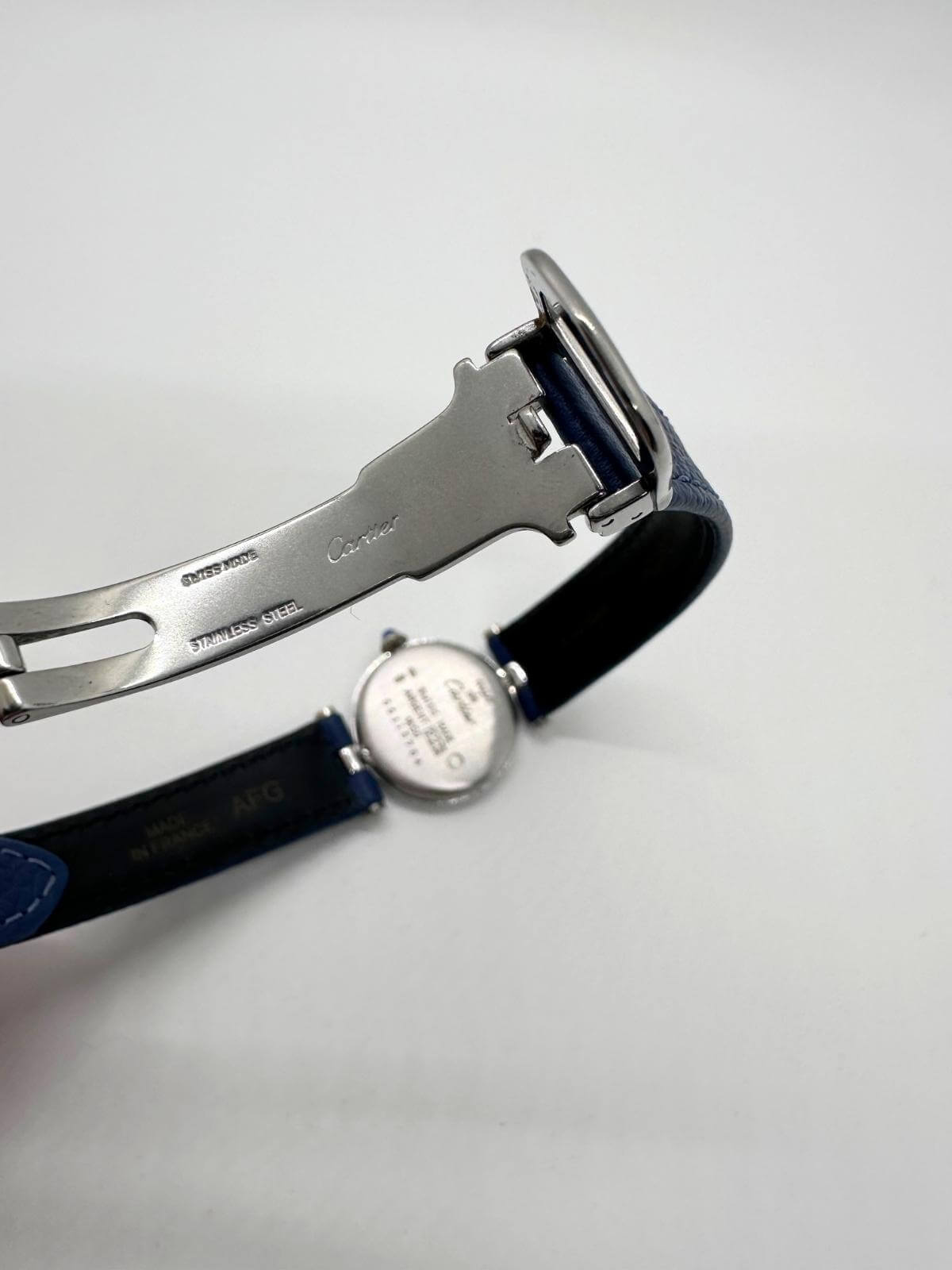 Detail of deployant buckle of watch on white background