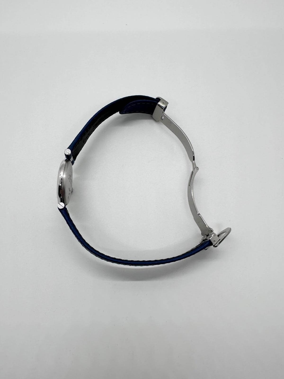 Side view of Cartier vendome silver watch on white background