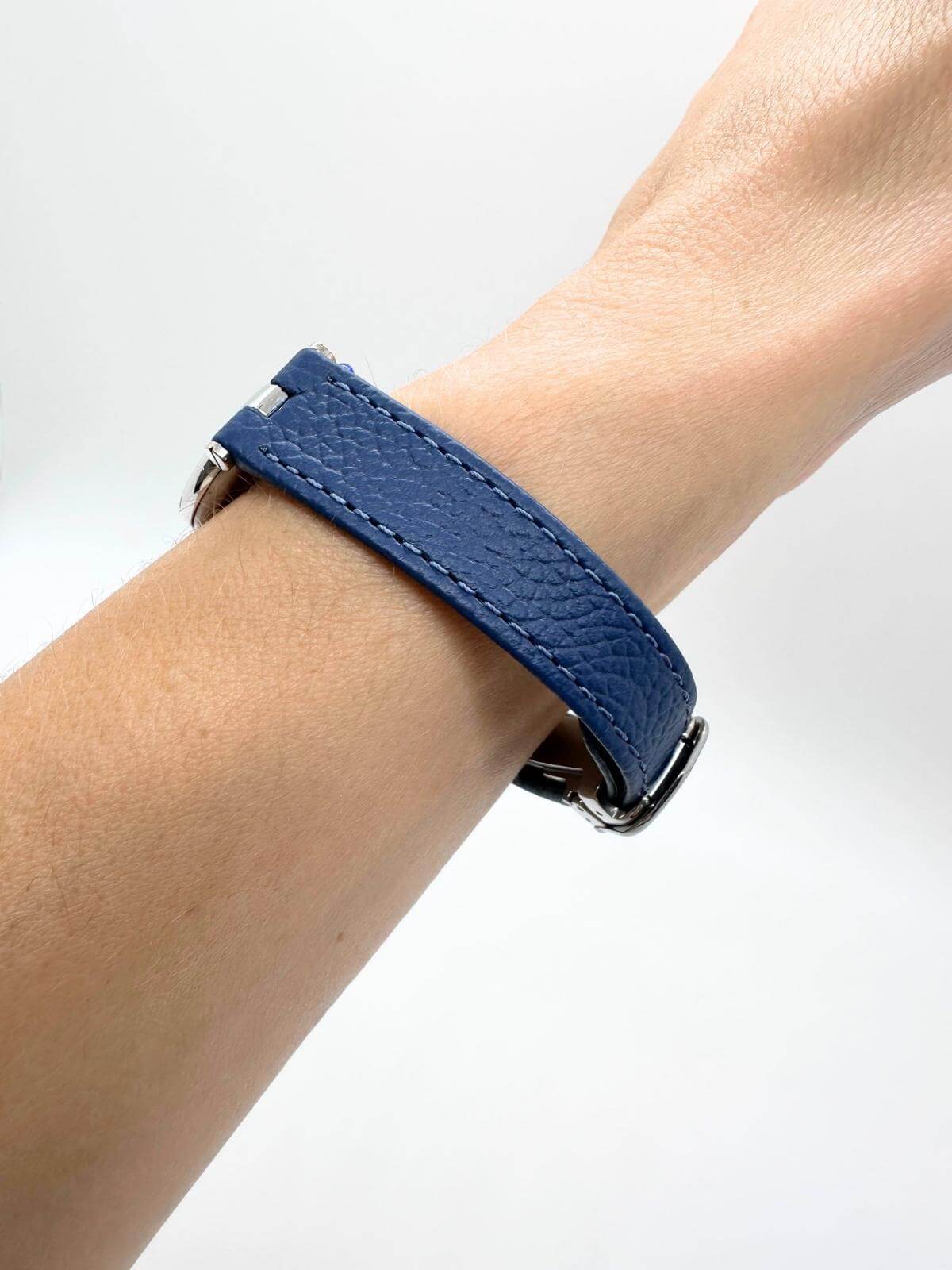 Side of blue strap on wrist with white background