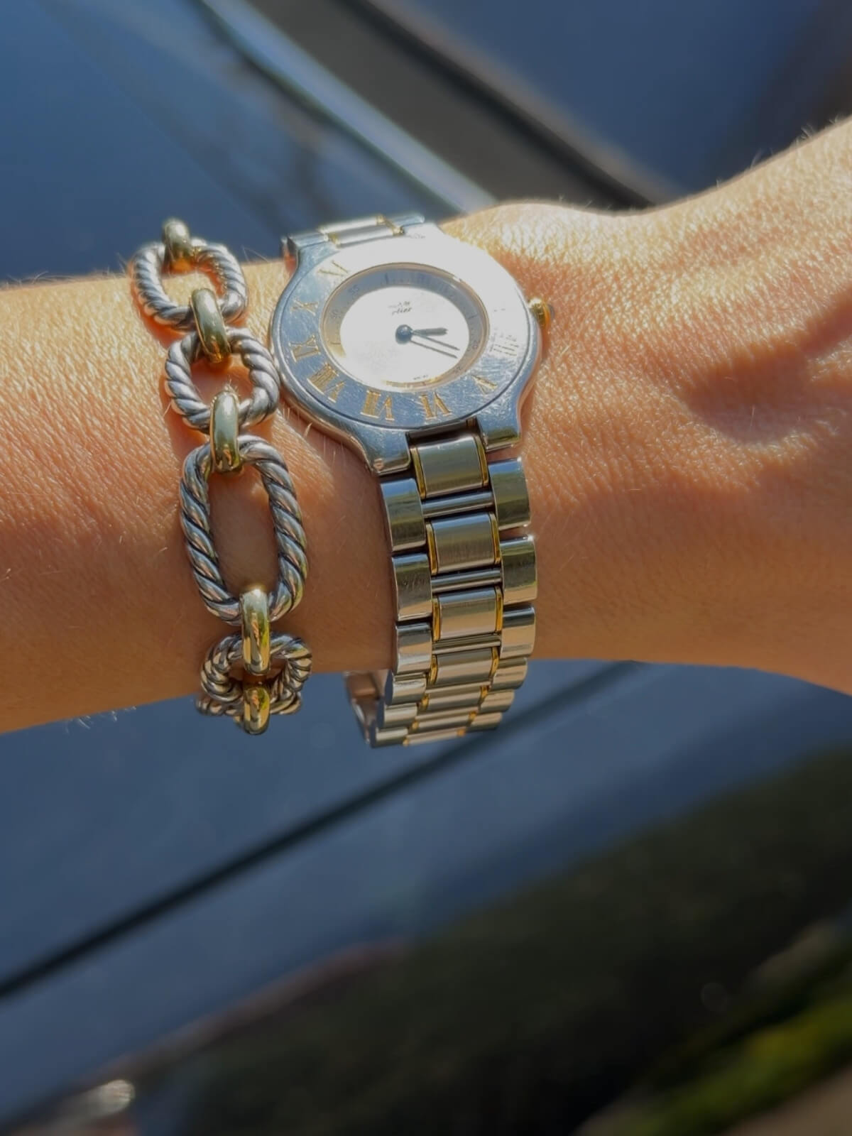 Louise Row featuring Model wearing Cartier must watch in stainless silver and gold round dial.