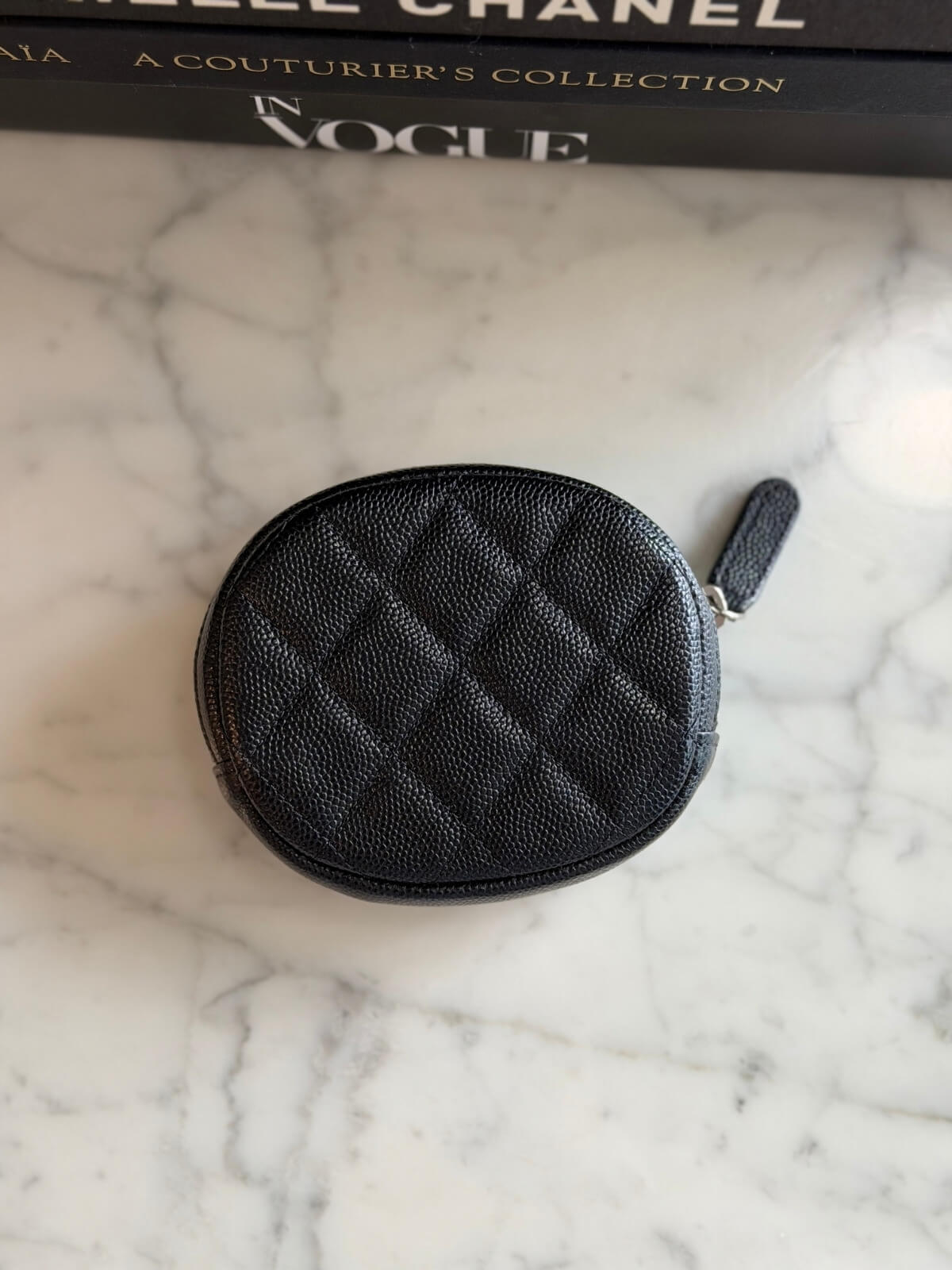 Louise Row featuring Chanel cavier coin purse on table