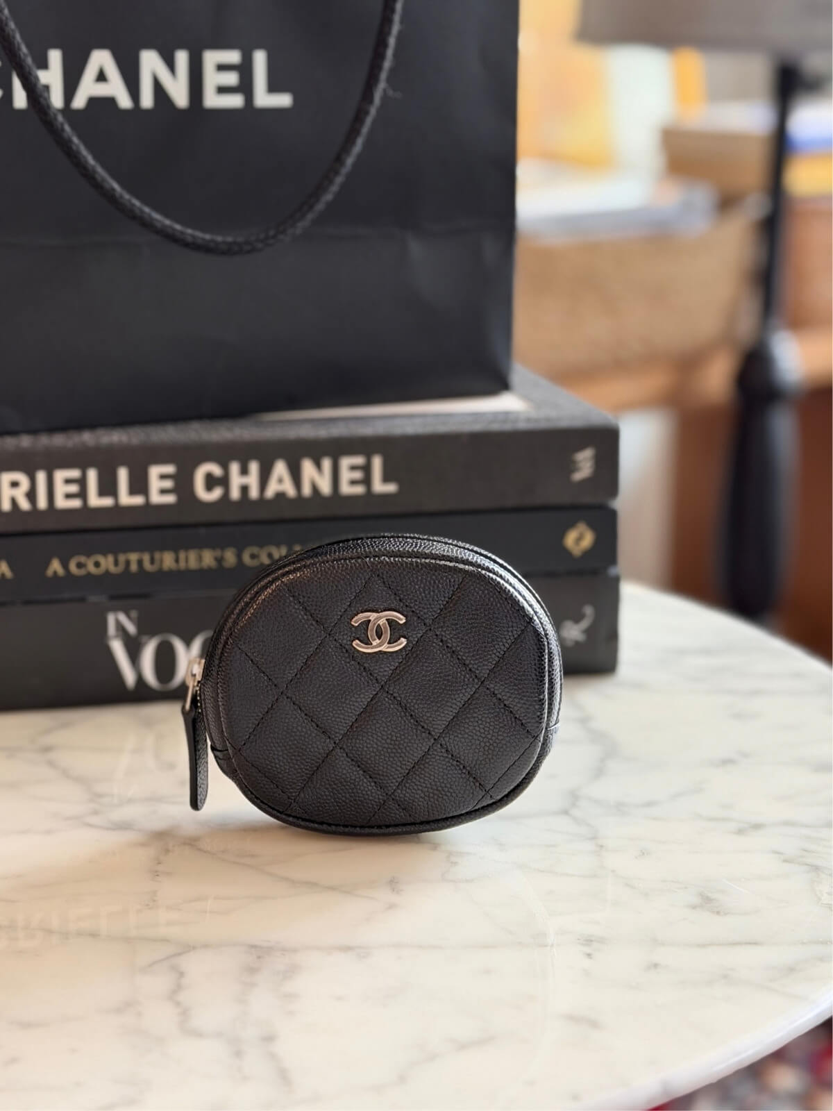 Louise Row featuring Chanel cavier coin purse on table