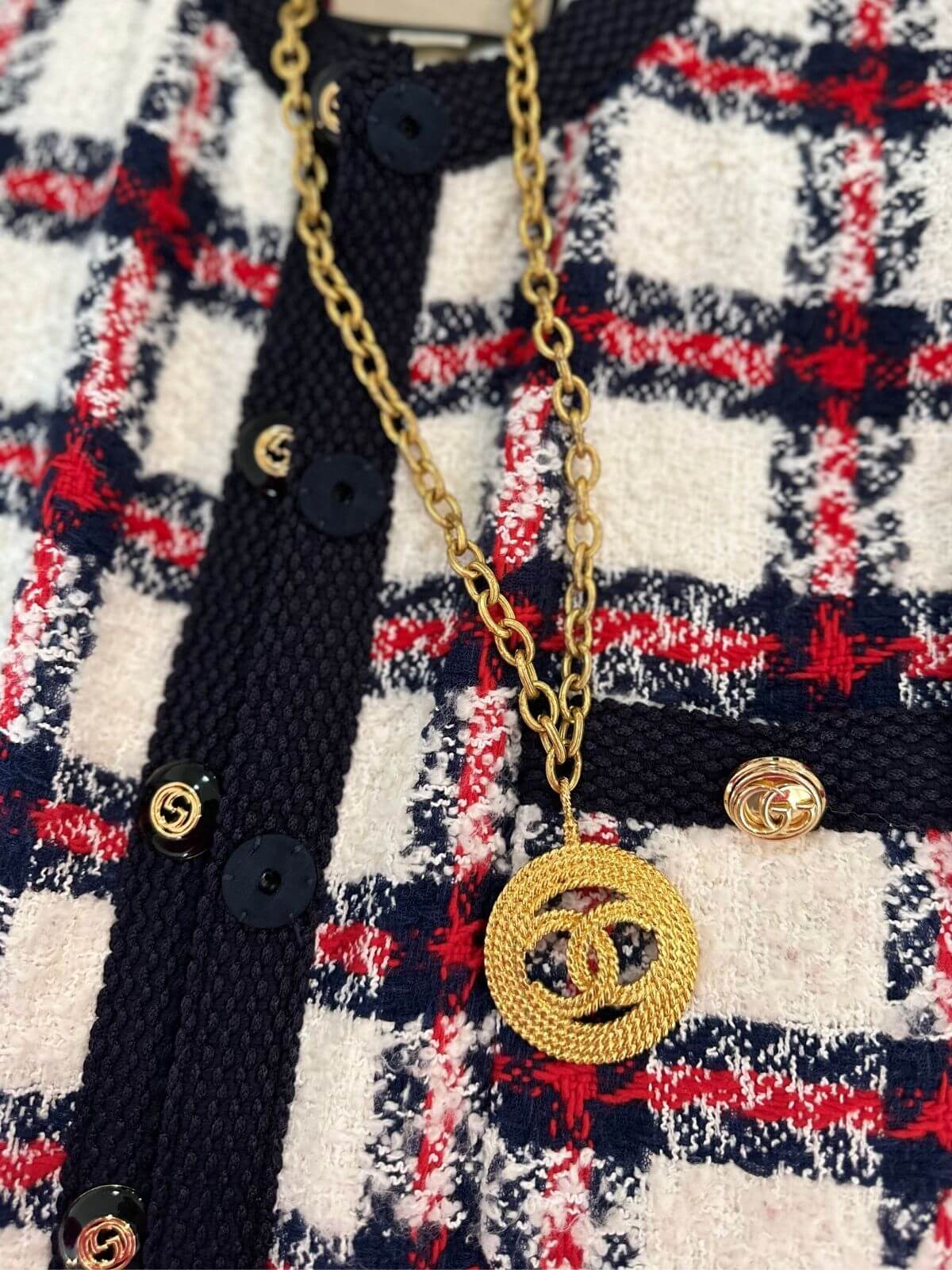 Chanel Logo necklace on plaid jacket