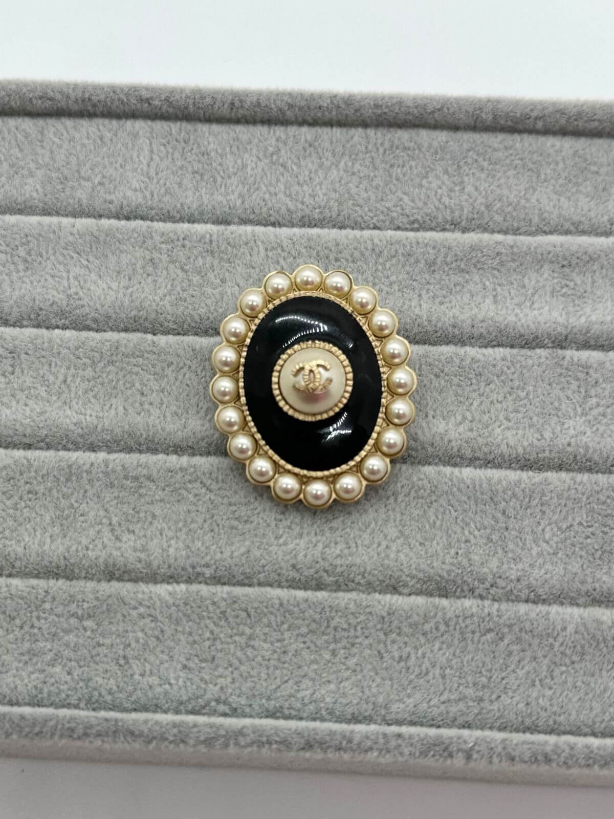 Chanel Oval brooch on grey background