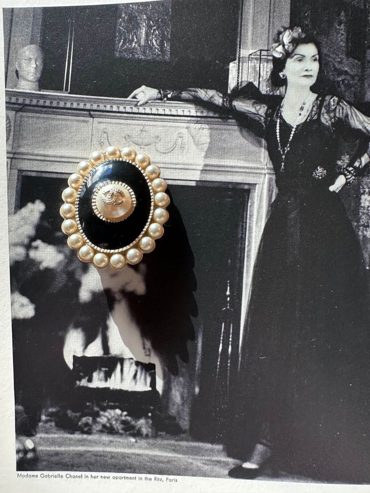 Chanel oval brooch on magazine
