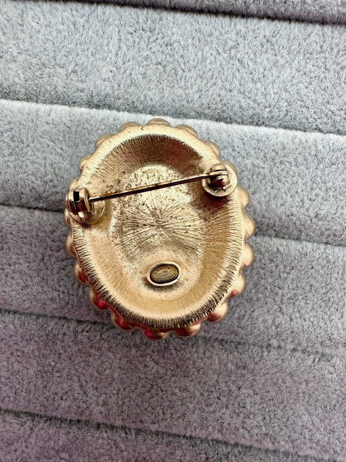 Chanel Oval brooch on grey background back detail