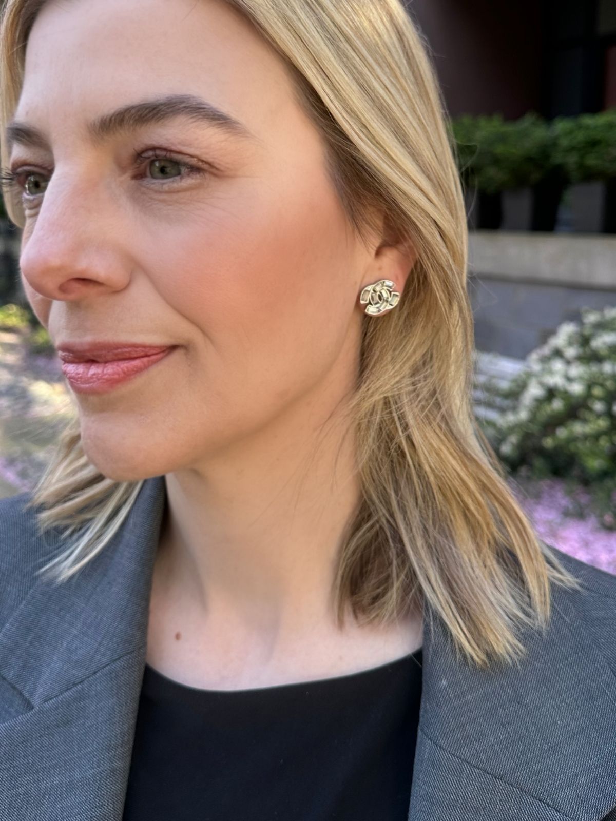 Louise Row Studio crystal Chanel earrings with a CC design on model with blonde hair