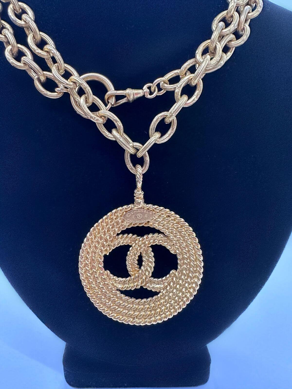 Louise Row Studio featuring Vintage Chanel medallion gold necklace showing Back of Chanel necklace with signature and stamp.