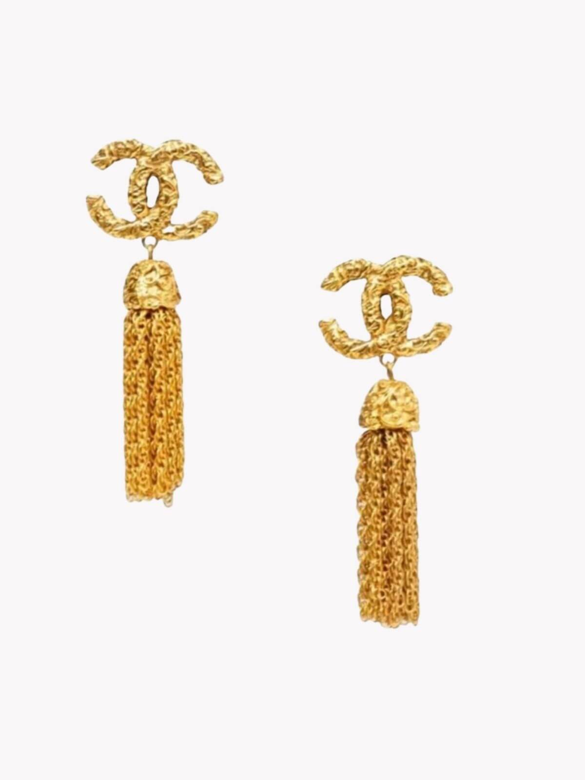 Louise Row Studio gold vintage Chanel tassel earrings on white background.