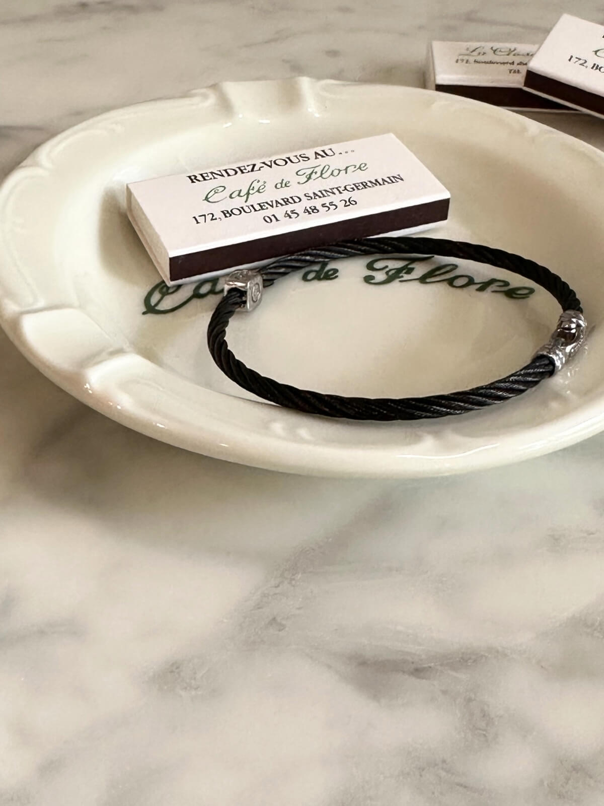 Louise Row Studio featuring Charriol black PVD bracelet on plate
