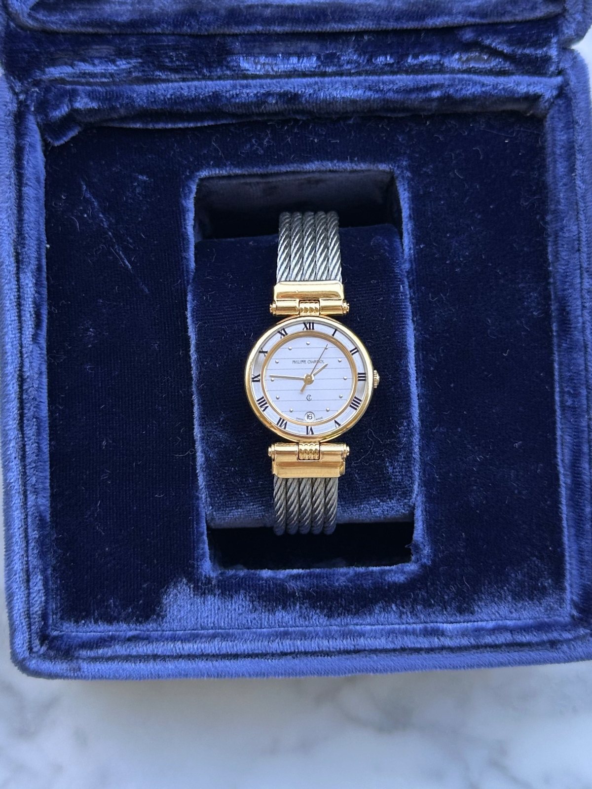 Louise Row Studio featuring Charriol 2-tone watch in blue display box.