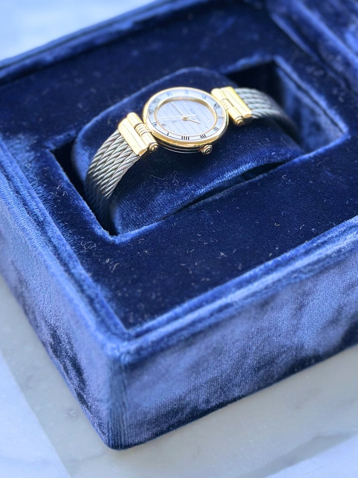 Louise Row Studio featuring Charriol 2-tone watch in blue display box.