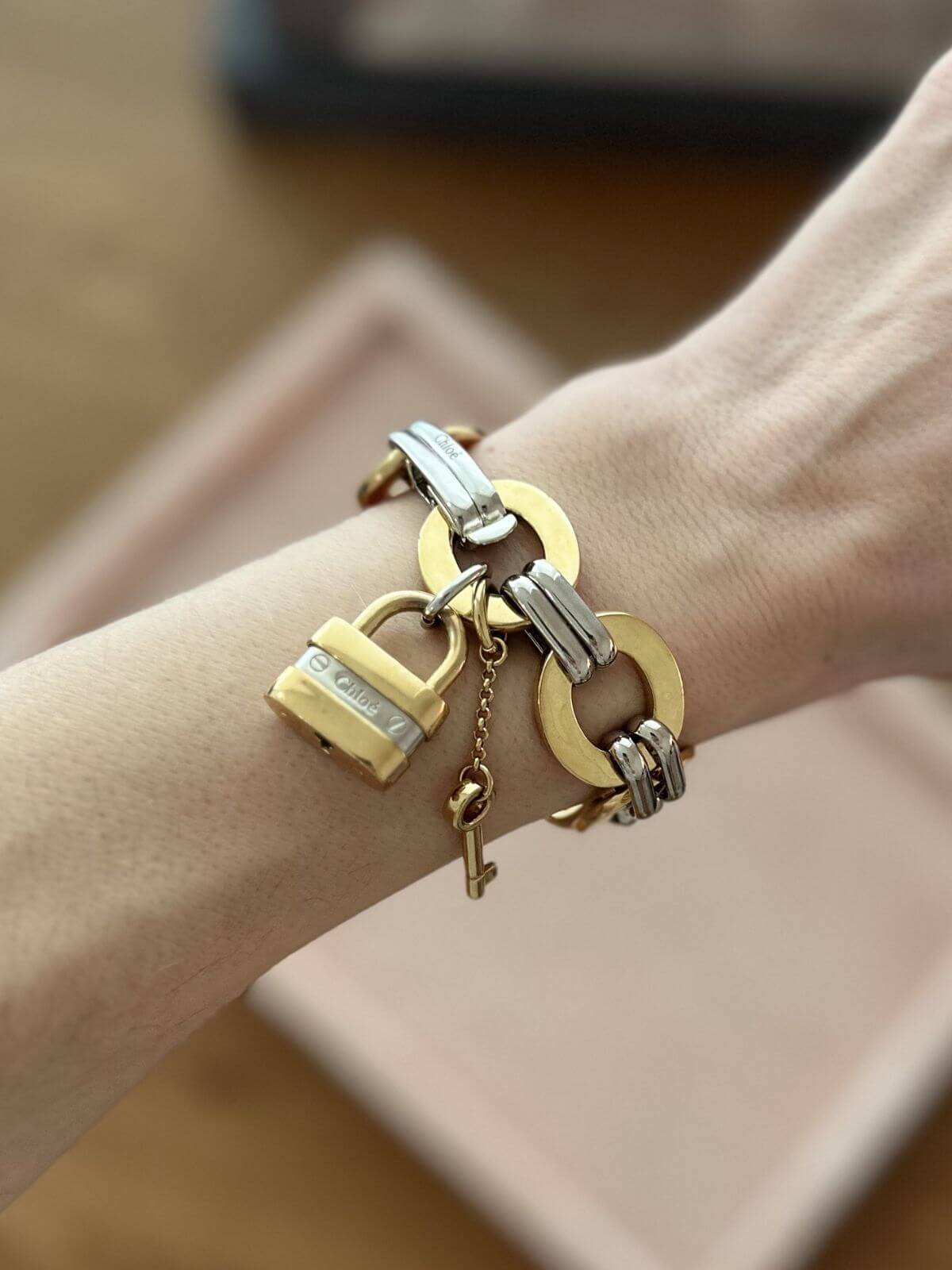 Chloe bracelet on pink display with lock charms on arm