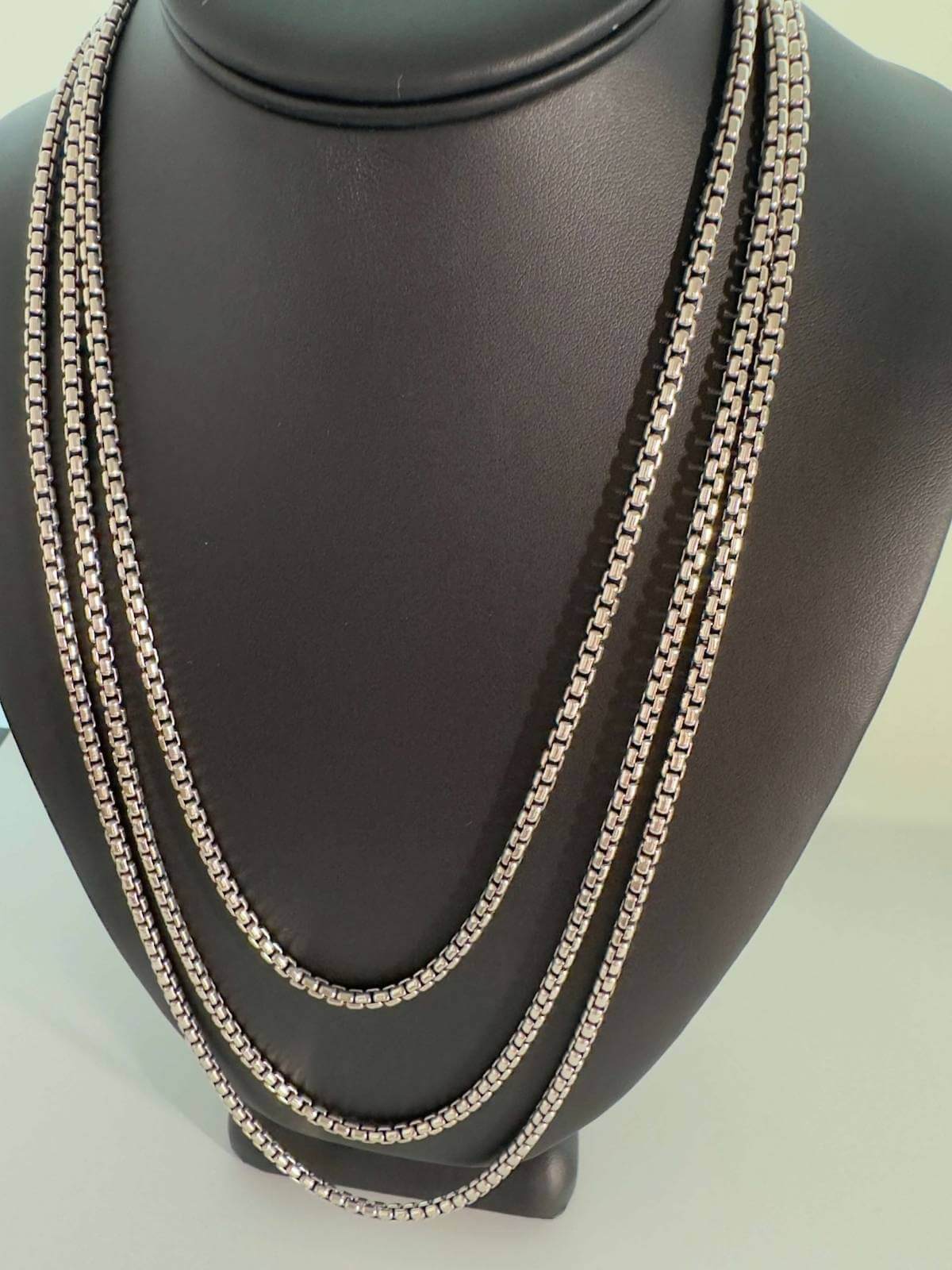 Silver chain necklace 72" wrapped 3 times on a mannequin bust