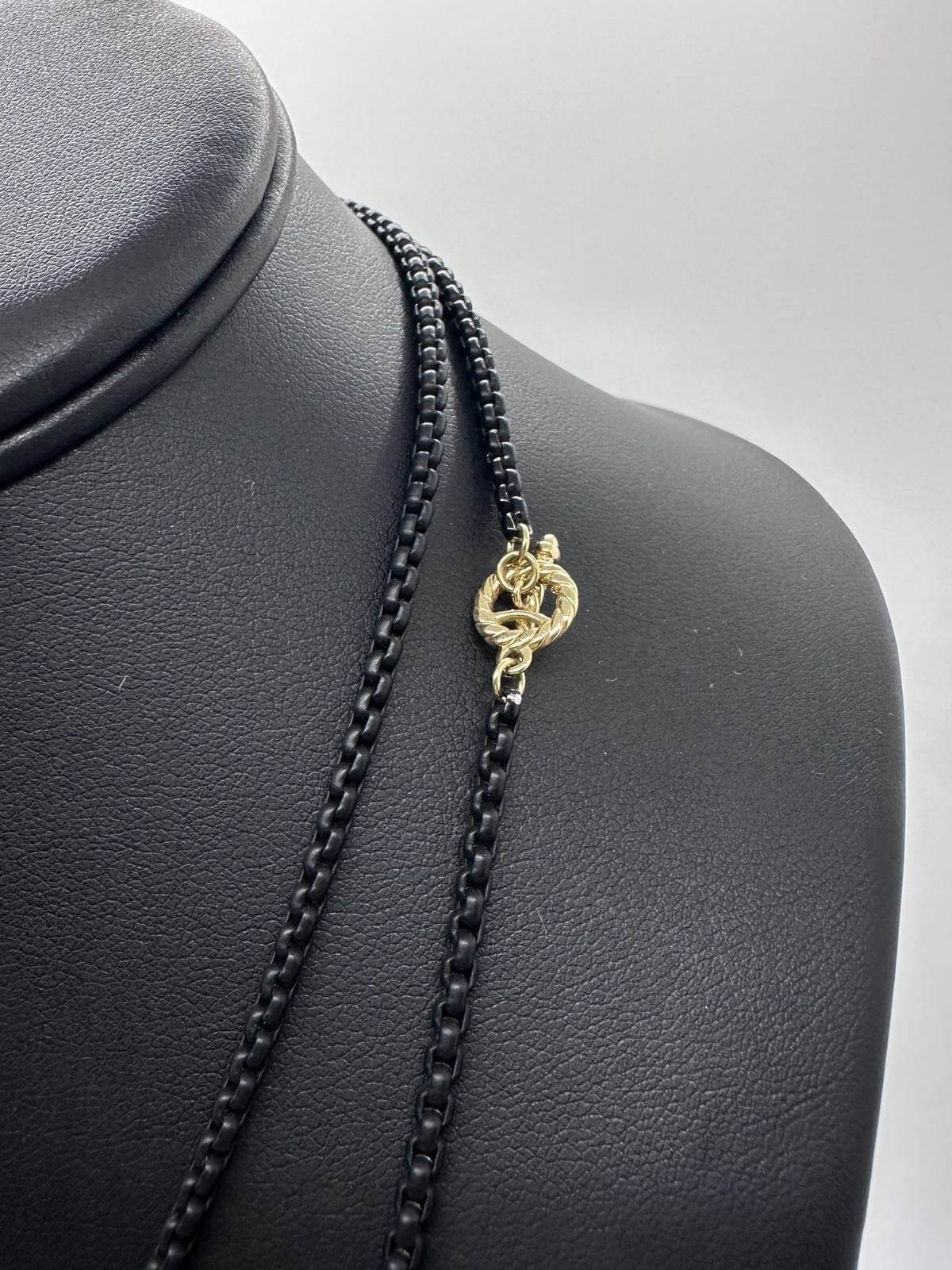 Detail of David Yurman Black chain necklace on a black mannequin bust with a white background