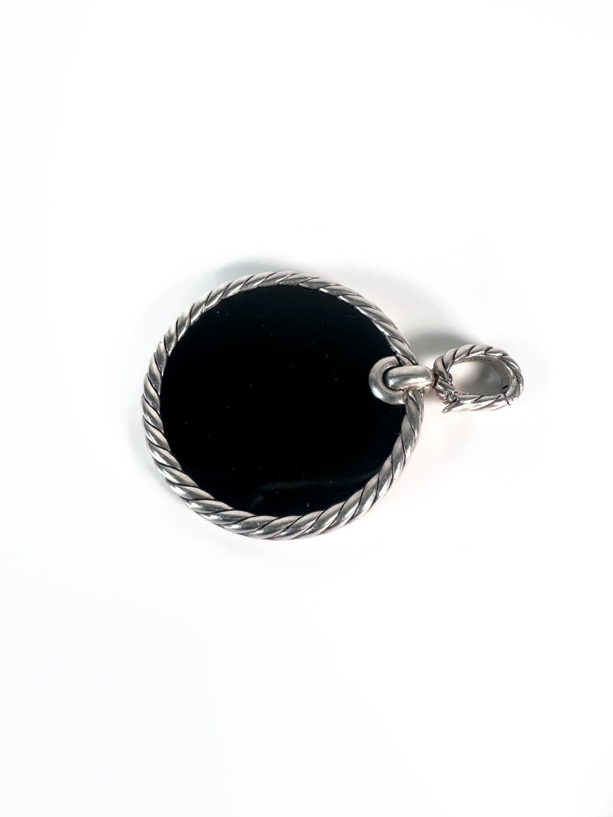 Back side of Silver pendant with diamond bezel with center stone black onyx on white background