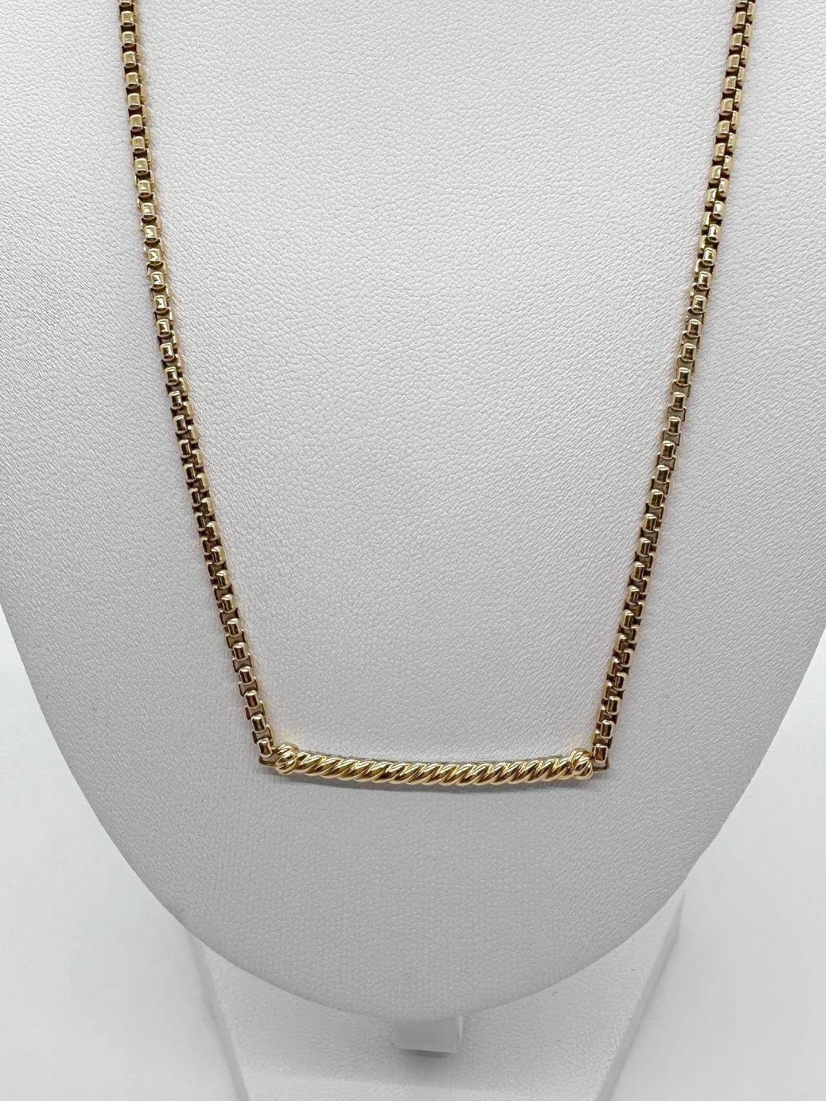 Back of gold David Yurman bar necklace on white background