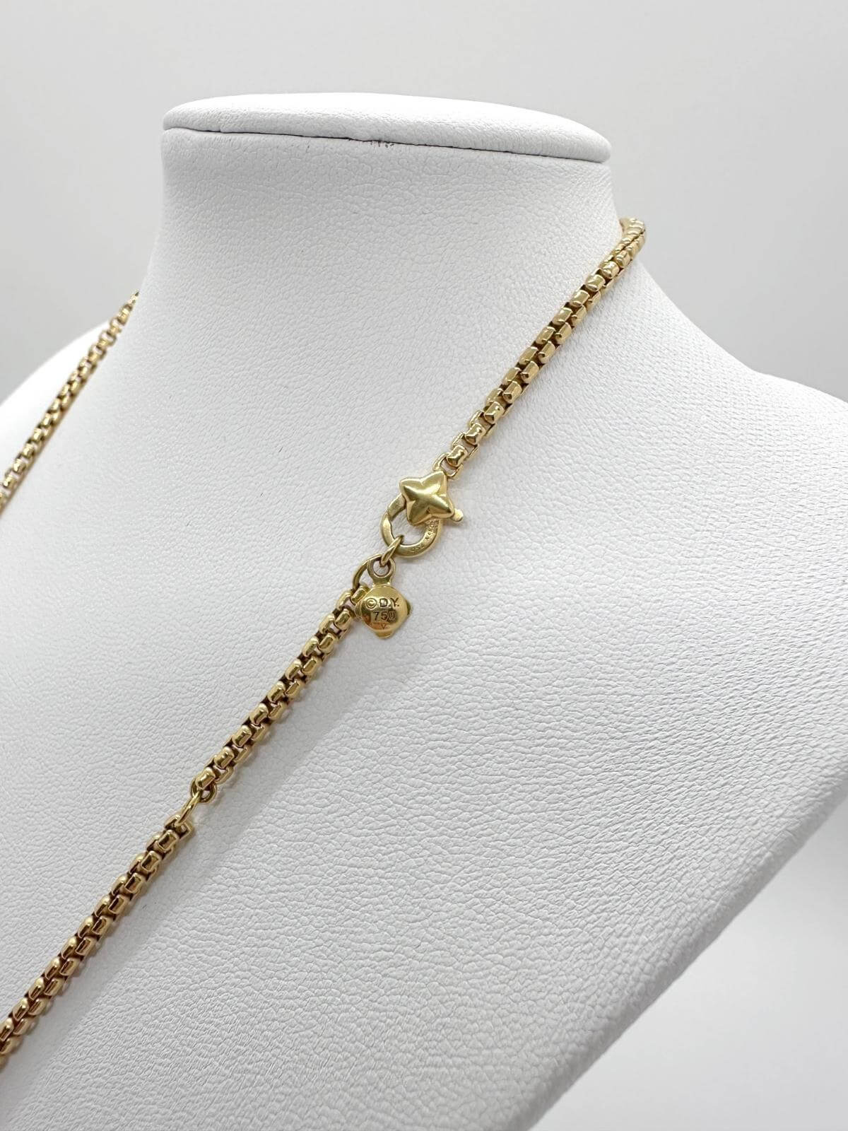 Detail of signature of necklace, and clasp on white background.