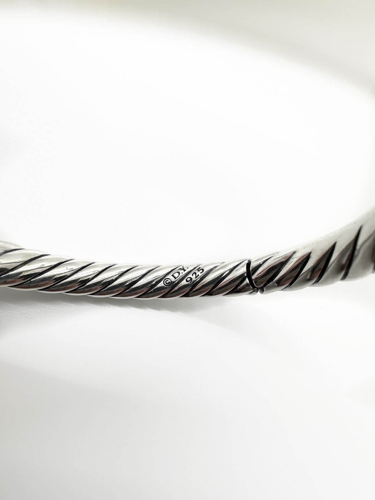 DY Silver Bangle on white background signature