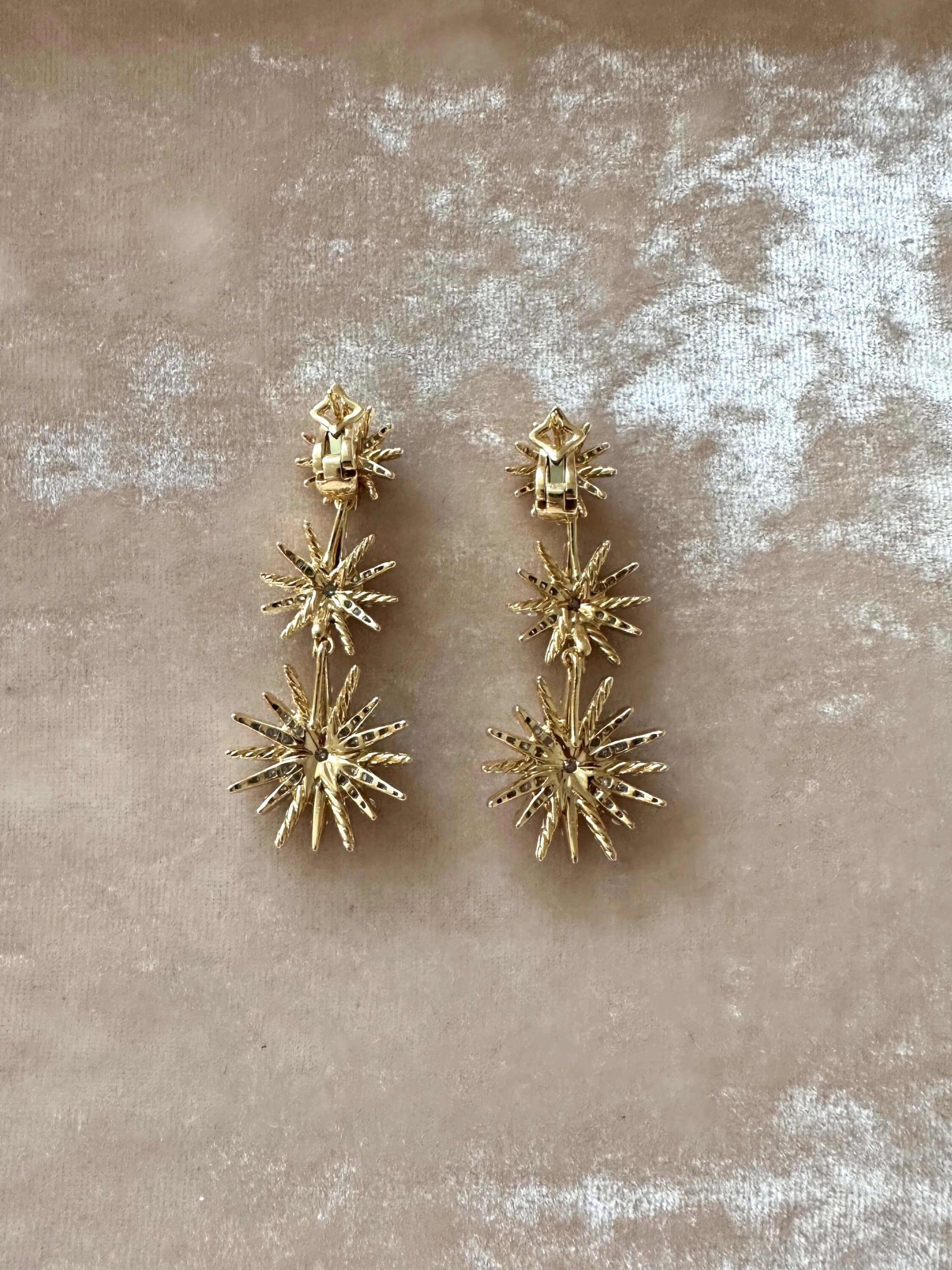 Louise Row Studio David Yurman 18K and diamond Starburst earrings, 3 drop convertible design on pink background.