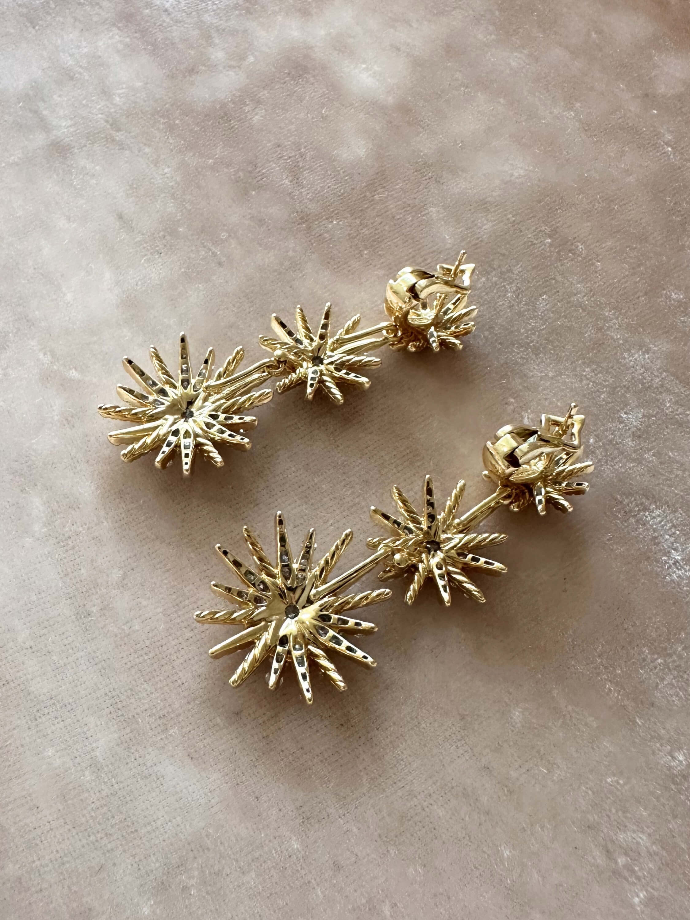 Louise Row Studio David Yurman 18K and diamond Starburst earrings, 3 drop convertible design on pink background.