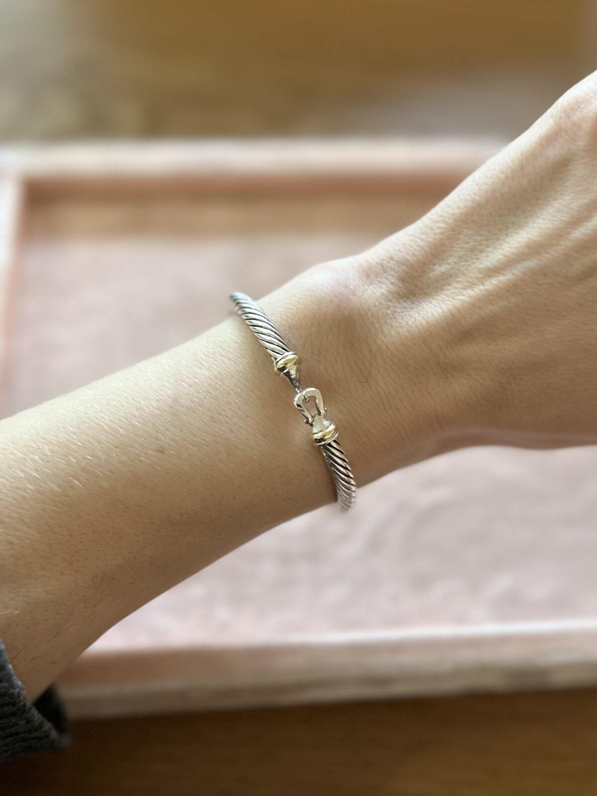 David Yurman silver buckle bracelet on wrist