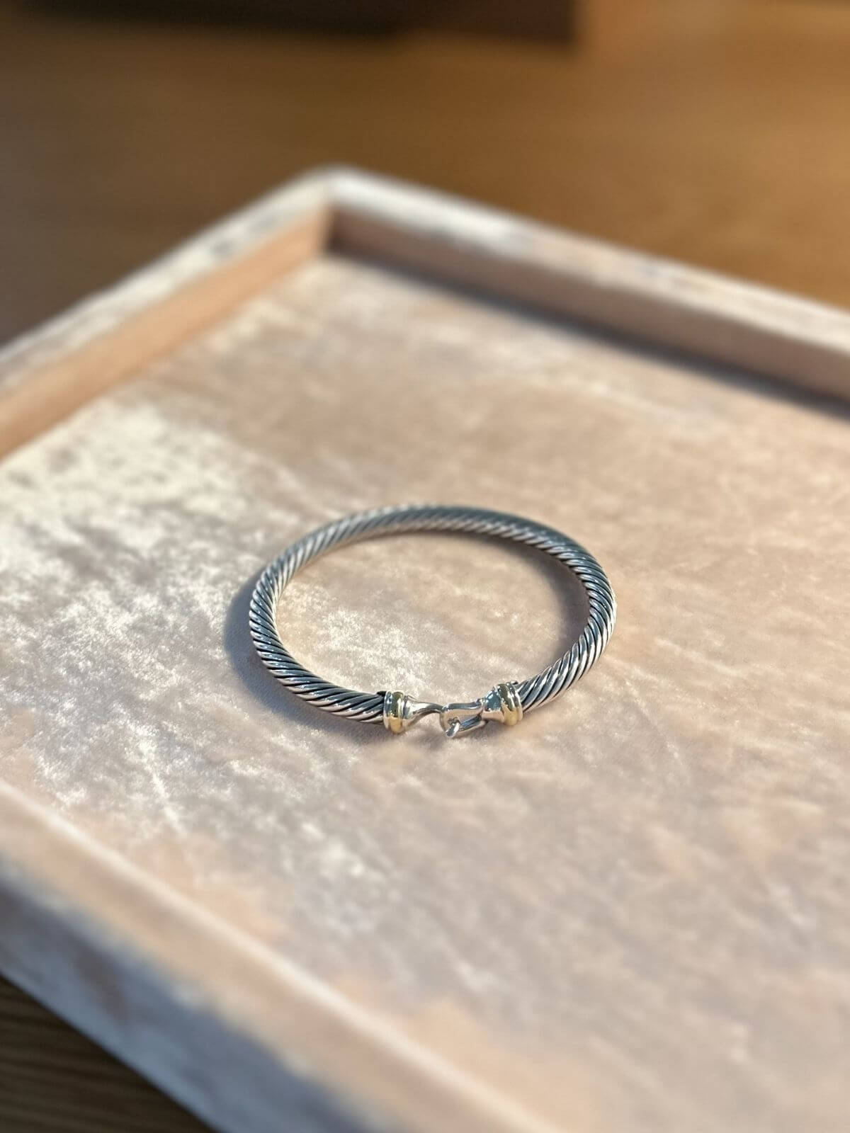 David Yurman buckle bracelet on pink velvet display