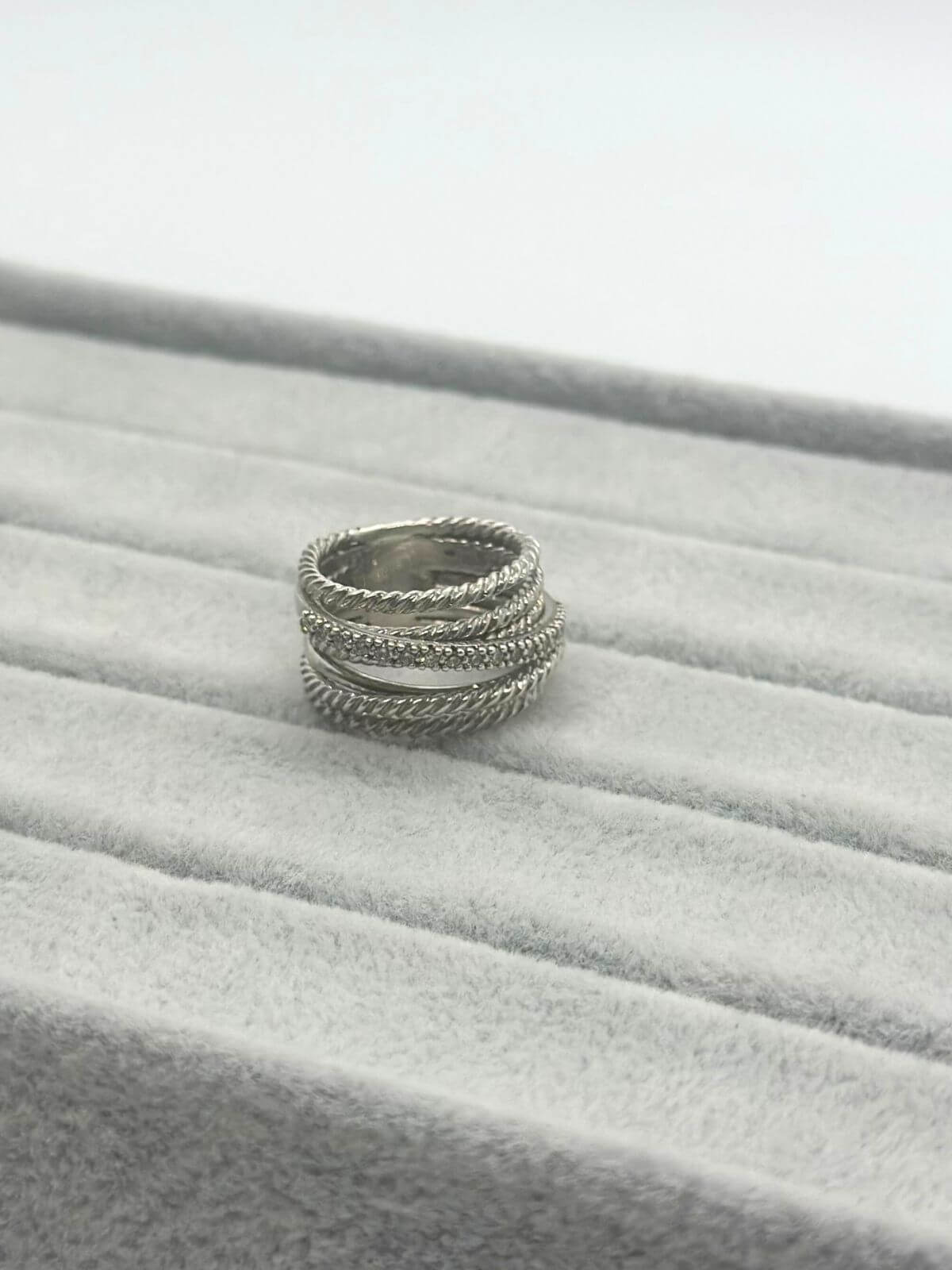 Silver David Yurman Crossover Ring with dia on grey background