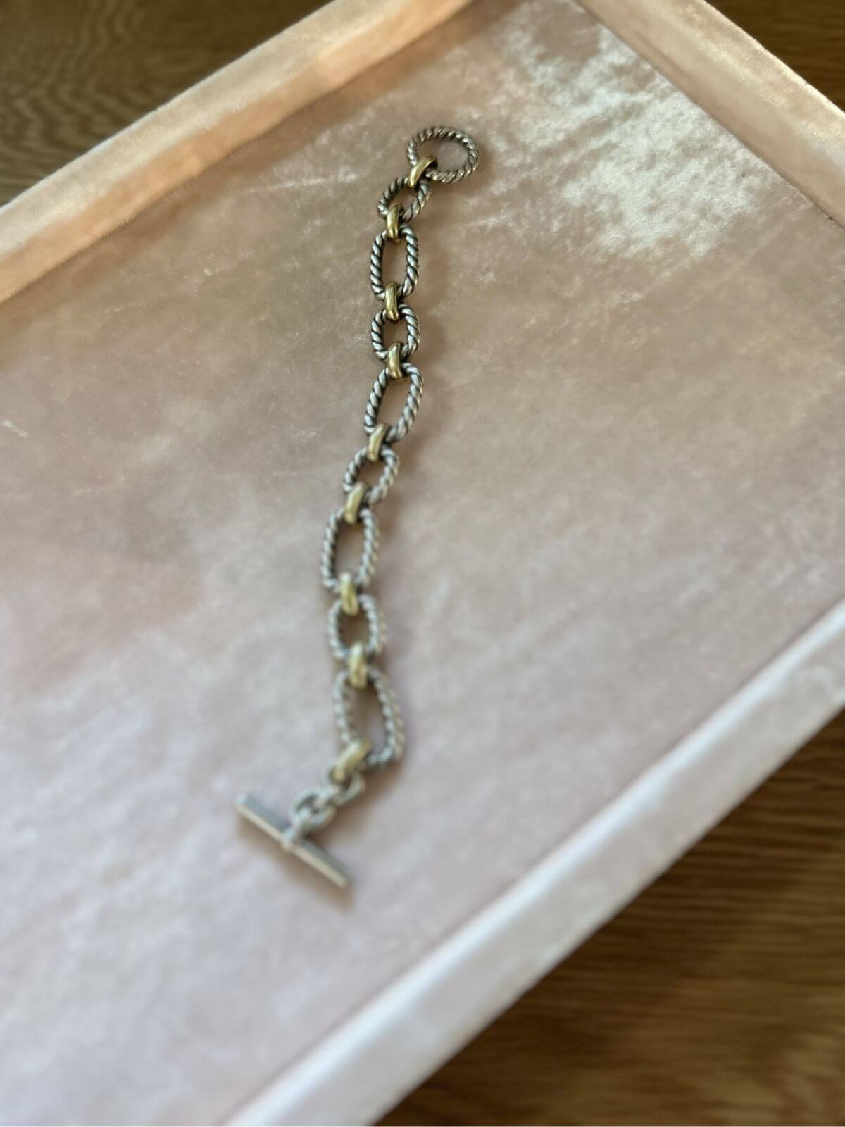 David Yurman gold and silver toggle bracelet on pink fixture