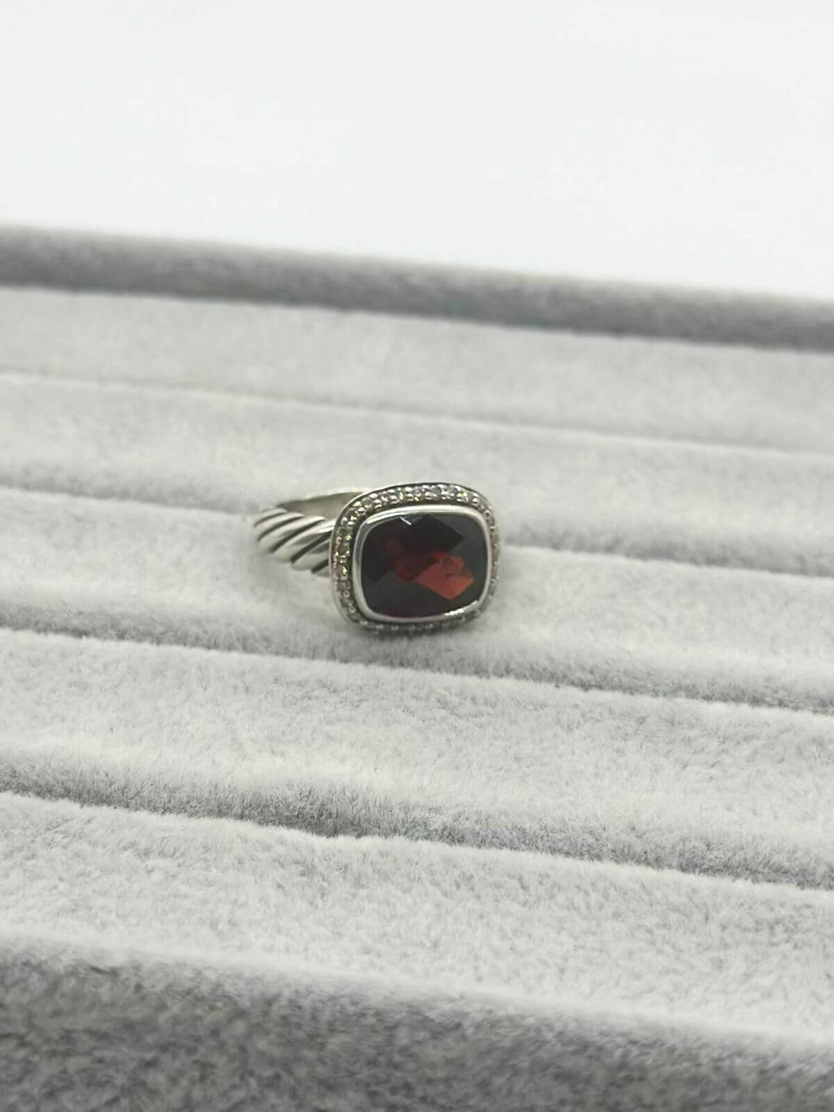 David Yurman Petite Noblesse Ring on grey fixture garnet and dia ring with silver.
