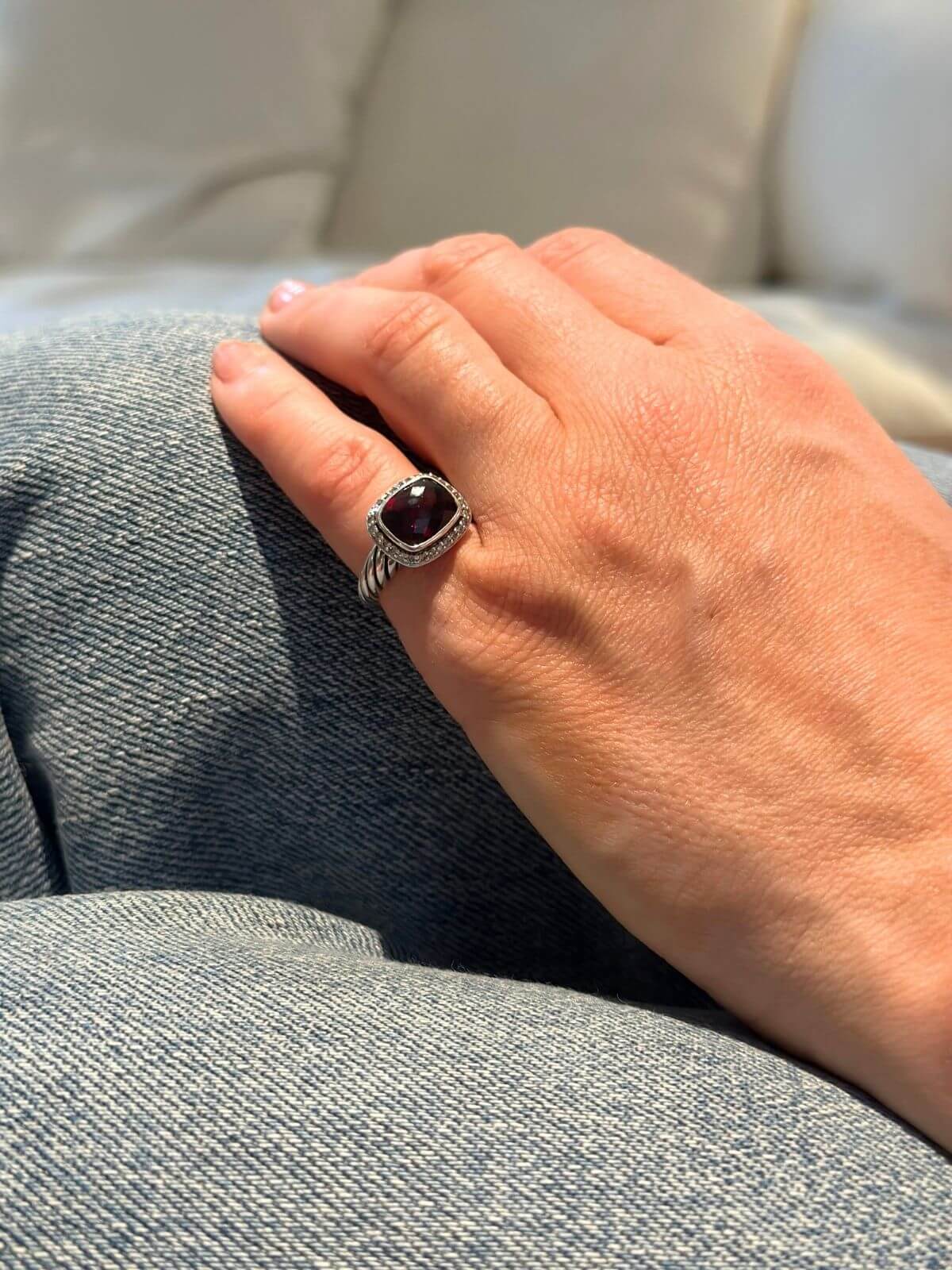 David Yurman Petite Noblesse Ring on model hand garnet and dia ring with silver.