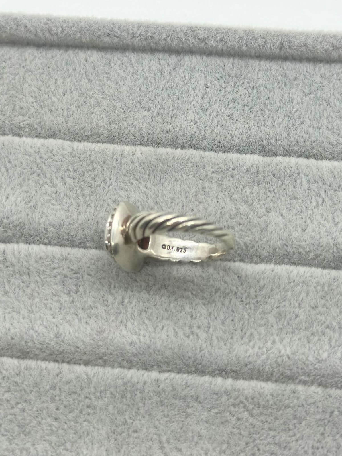 David Yurman Petite Noblesse Ring on grey fixture garnet and dia ring with silver.