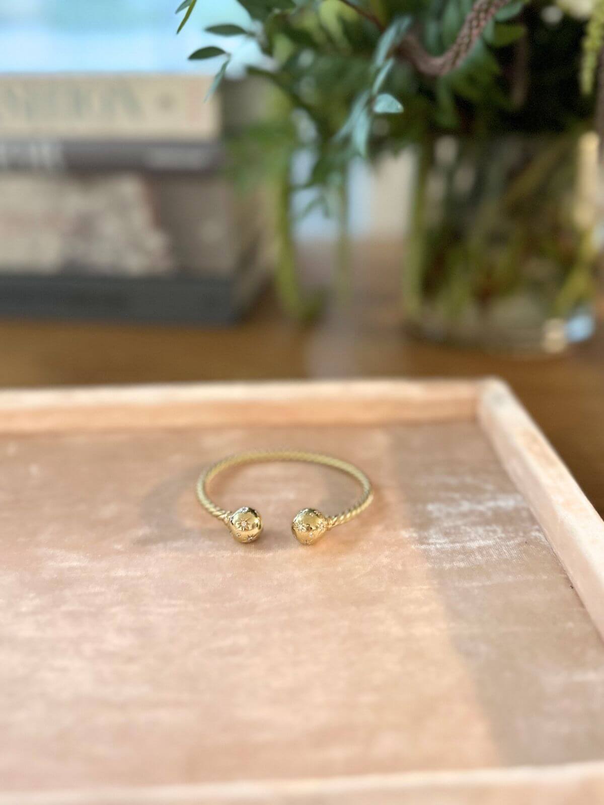 Gold David Yurman Solari bracelet on pink tray