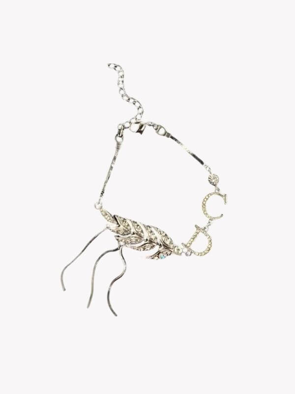 Louise Row Studio featuring Dior silver feather inspired bracelet made of silver and crystals on white background.