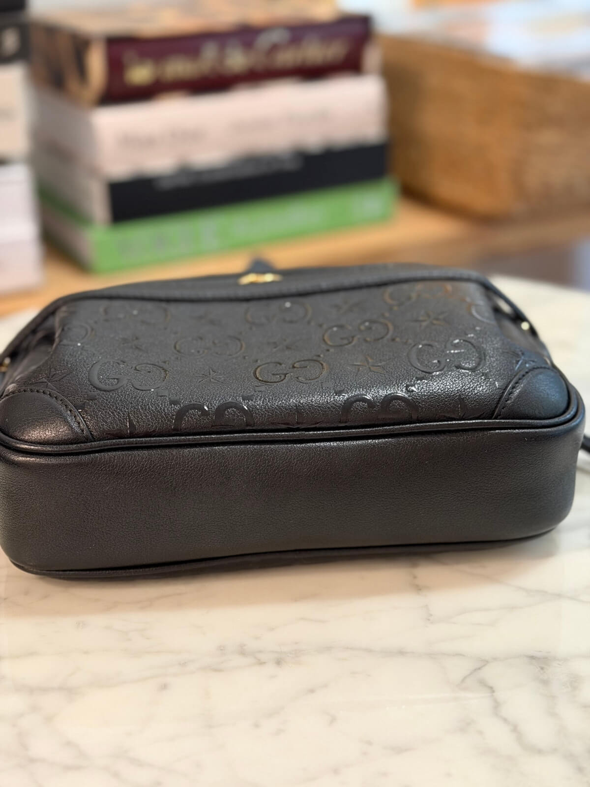 Louise Row featuring Gucci Star Monogram bag on table