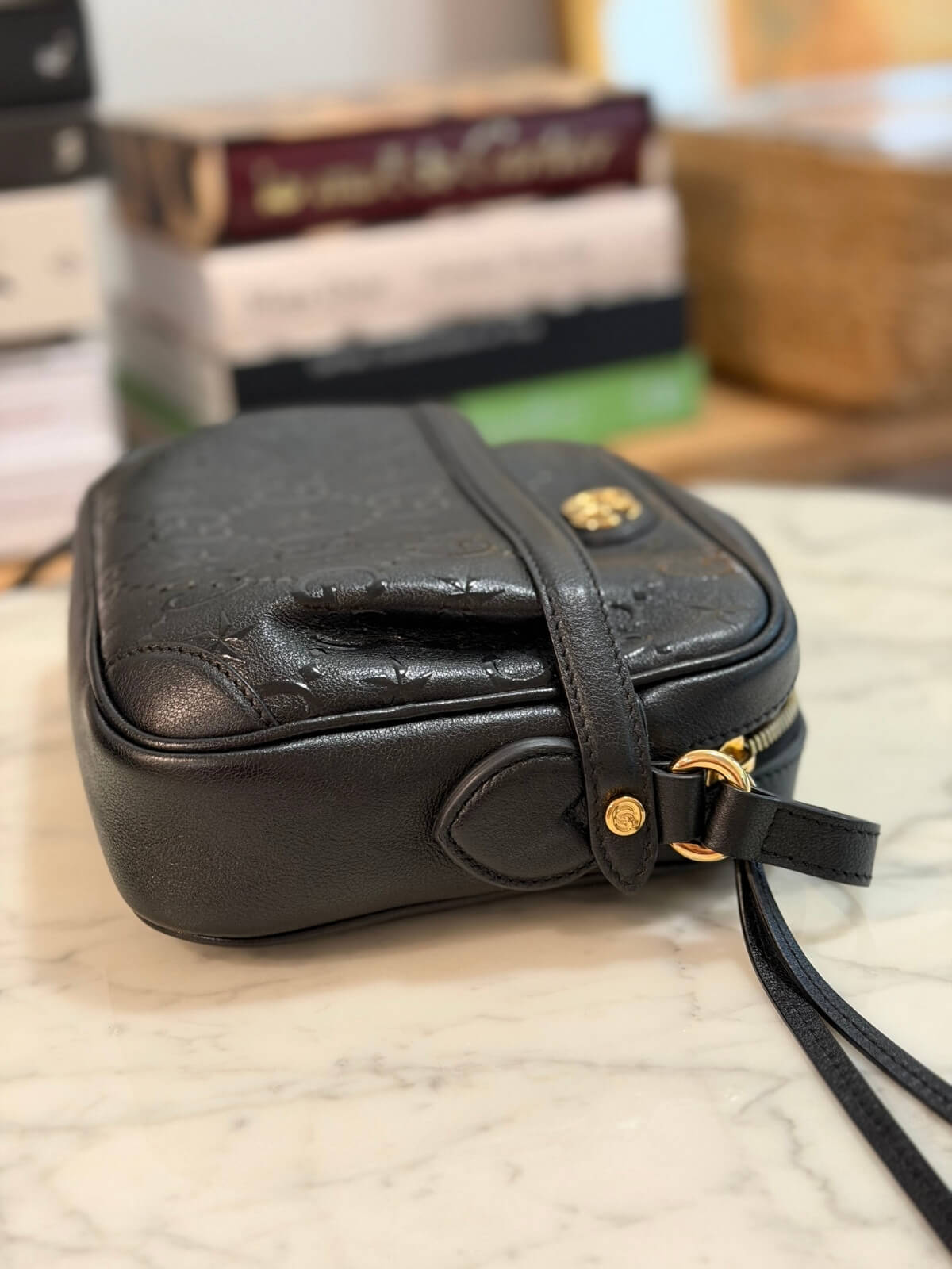 Louise Row featuring Gucci Star Monogram bag on table