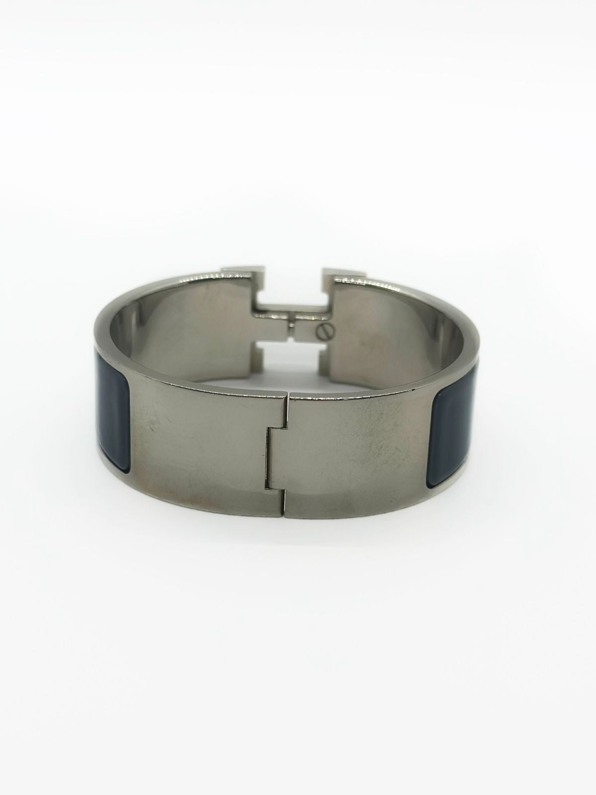 Hermes Clic H Bracelet in stainless steel and enamel on white background. Grey enamel with H in center.