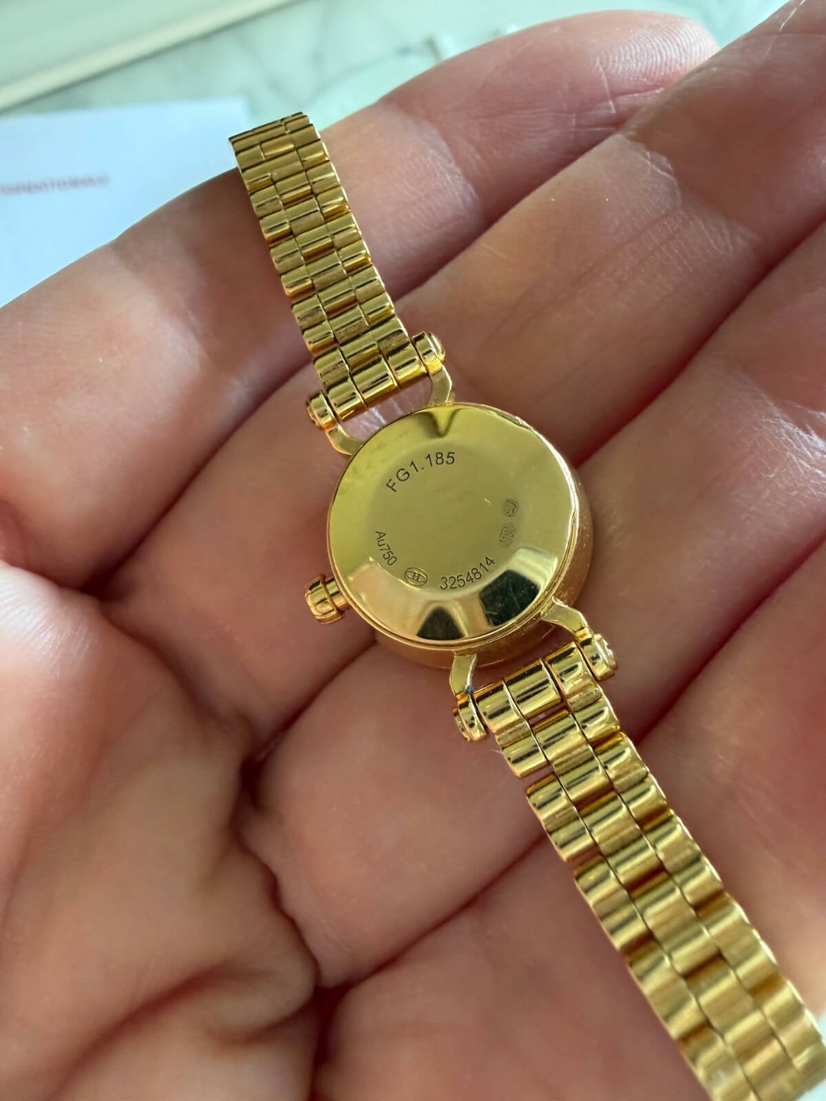 Louise Row featuring Hermes 18K yellow gold Faubourg watch on plate back side of bezel