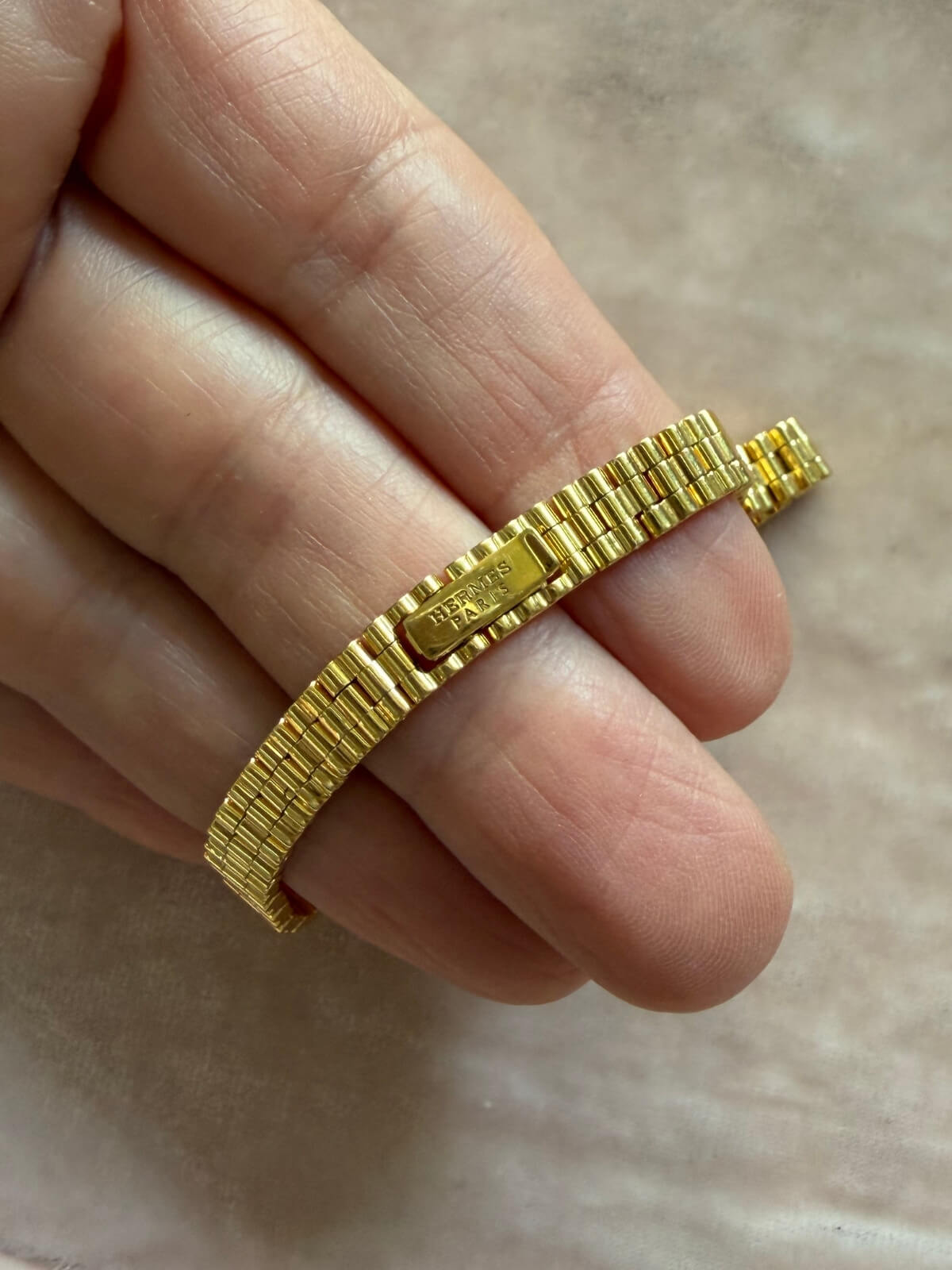 Louise Row featuring Hermes 18K yellow gold Faubourg watch on hand showing signature on back side