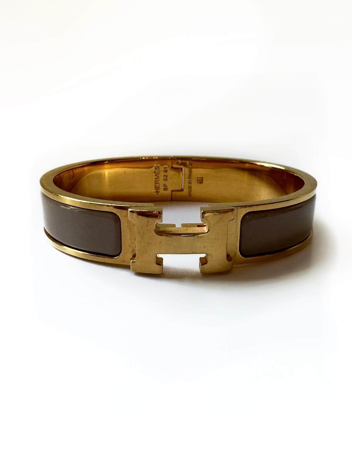 Front view of Hermes Clic H Bracelet with box on white background